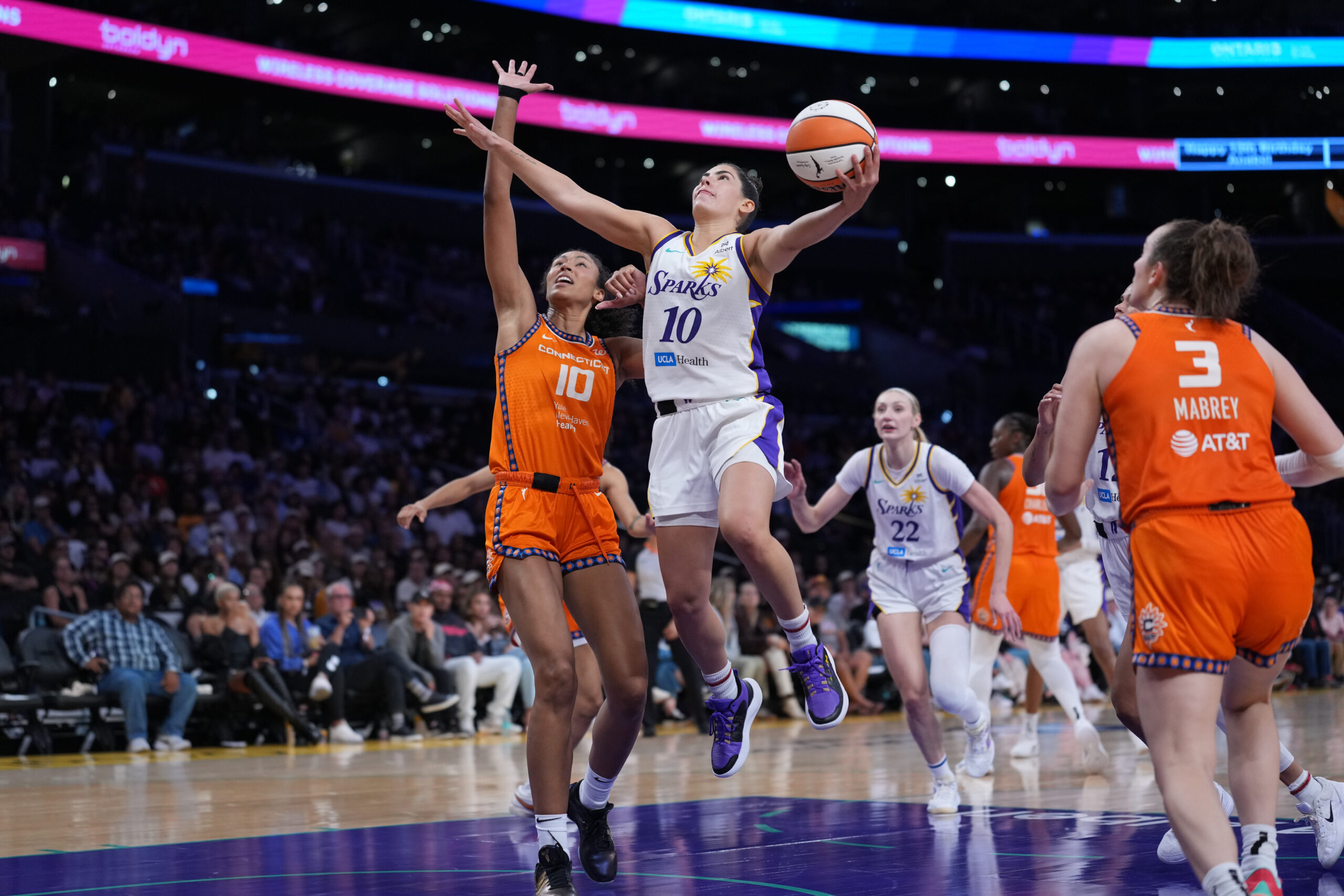 Aug 7, 2025; Los Angeles, California, USA; LA Sparks guard Kelsey Plum (10) goes up for a shot while defended by Connecticut Sun center Olivia Nelson-Ododa (10) in the second half at Crypto.com Arena. Mandatory Credit: Kirby Lee-Imagn Images