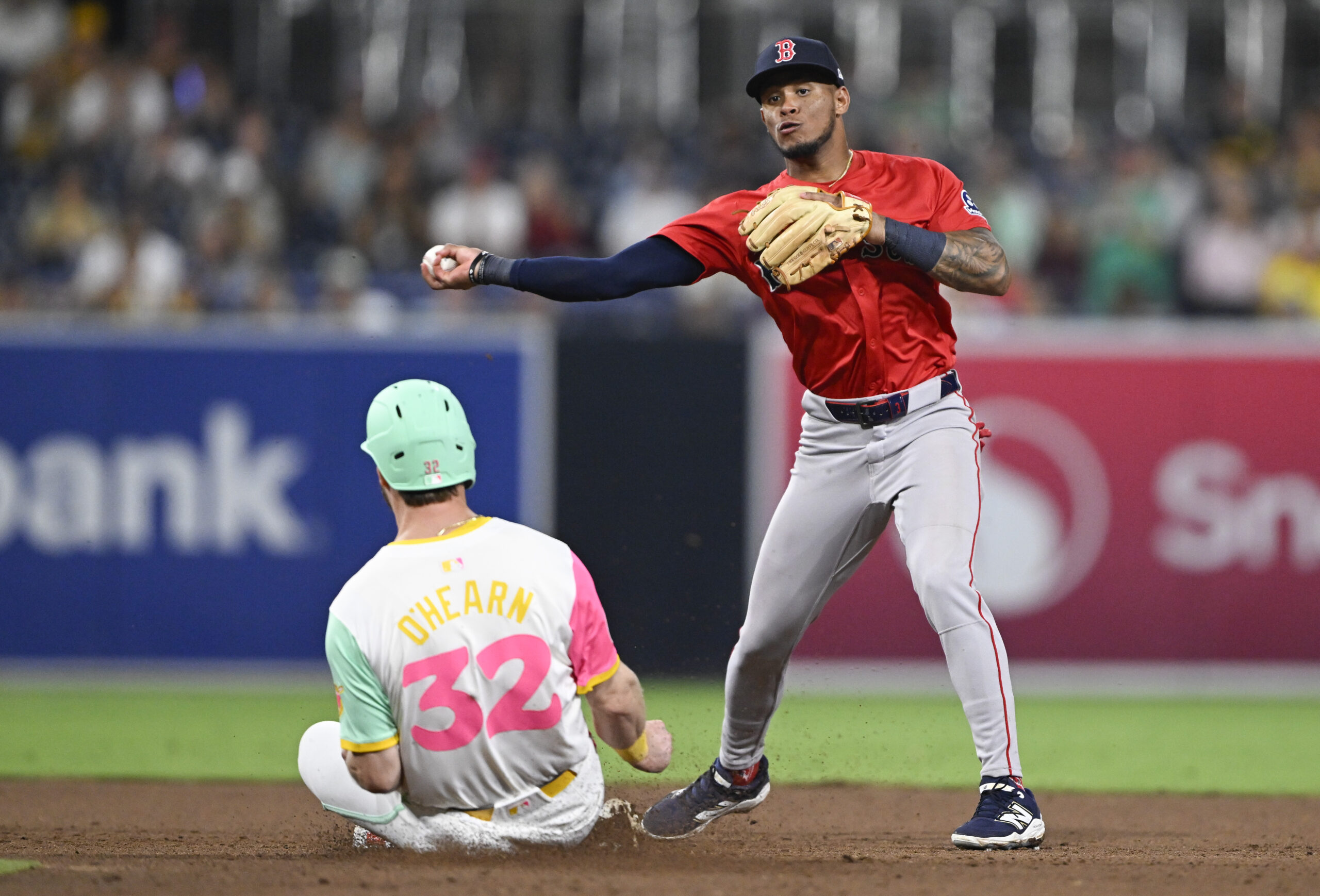 Aug 8, 2025; San Diego, California, USA; Boston Red Sox center fielder Ceddanne Rafaela (3) throws over San Diego Padres first baseman Ryan O'Hearn (32) as he tries to turn a double play during the eighth inning at Petco Park. Mandatory Credit: Denis Poroy-Imagn Images
