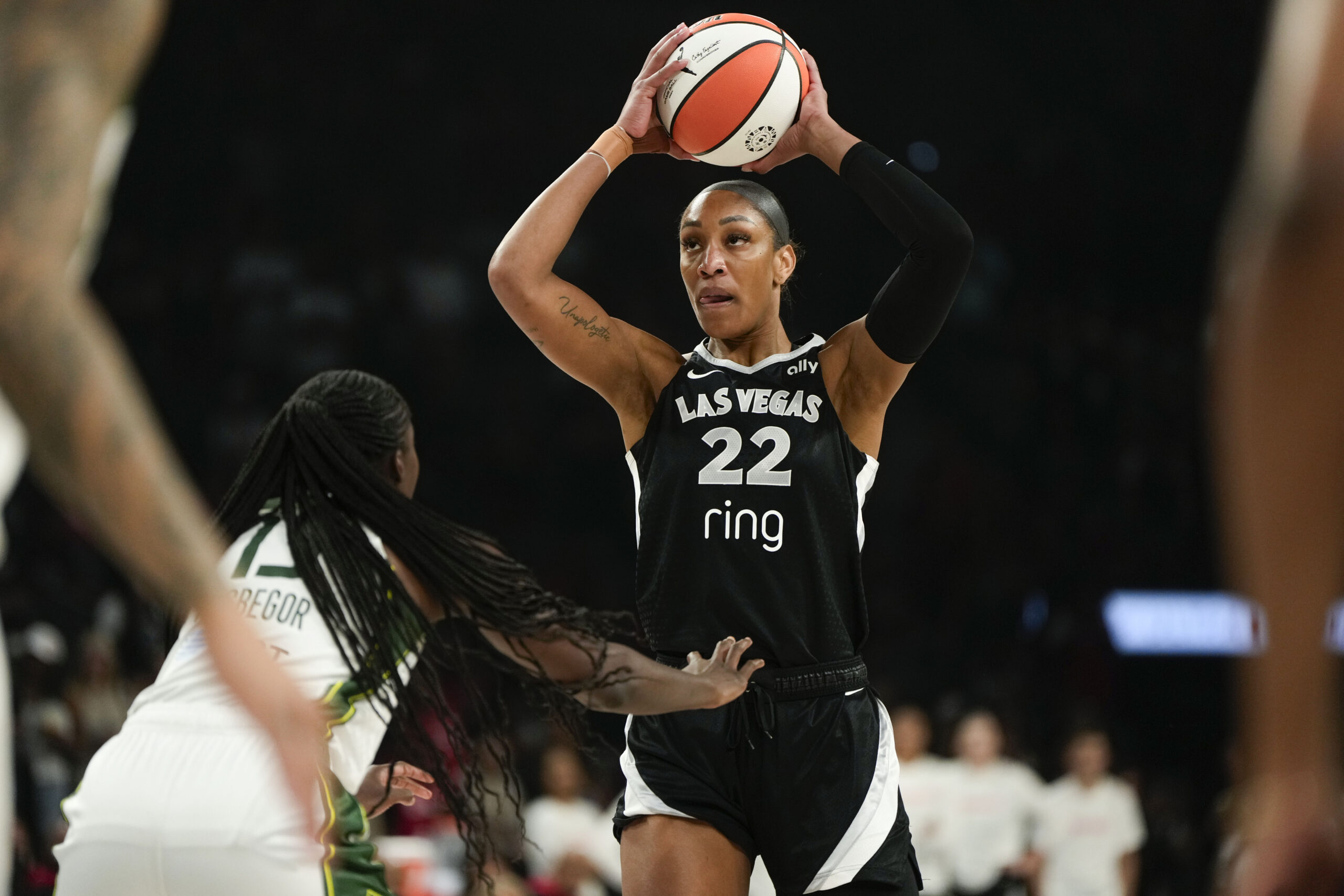 Aug 8, 2025; Las Vegas, Nevada, USA; Las Vegas Aces center A'ja Wilson (22) controls the ball against Seattle Storm forward Ezi Magbegor (13) during the first half of a WNBA basketball game at Michelob Ultra Arena. Mandatory Credit: Lucas Peltier-Imagn Images