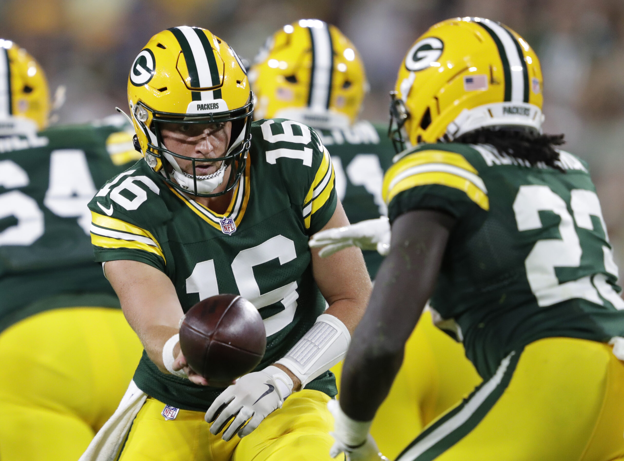Aug 9, 2025; Green Bay, Wisconsin, USA; Green Bay Packers quarterback Sean Clifford (16) hands off the ball to running back Israel Abanikanda (23) against the New York Jets during the second half at Lambeau Field. Mandatory Credit: Dan Powers/USA TODAY NETWORK-Wisconsin/Imagn Images