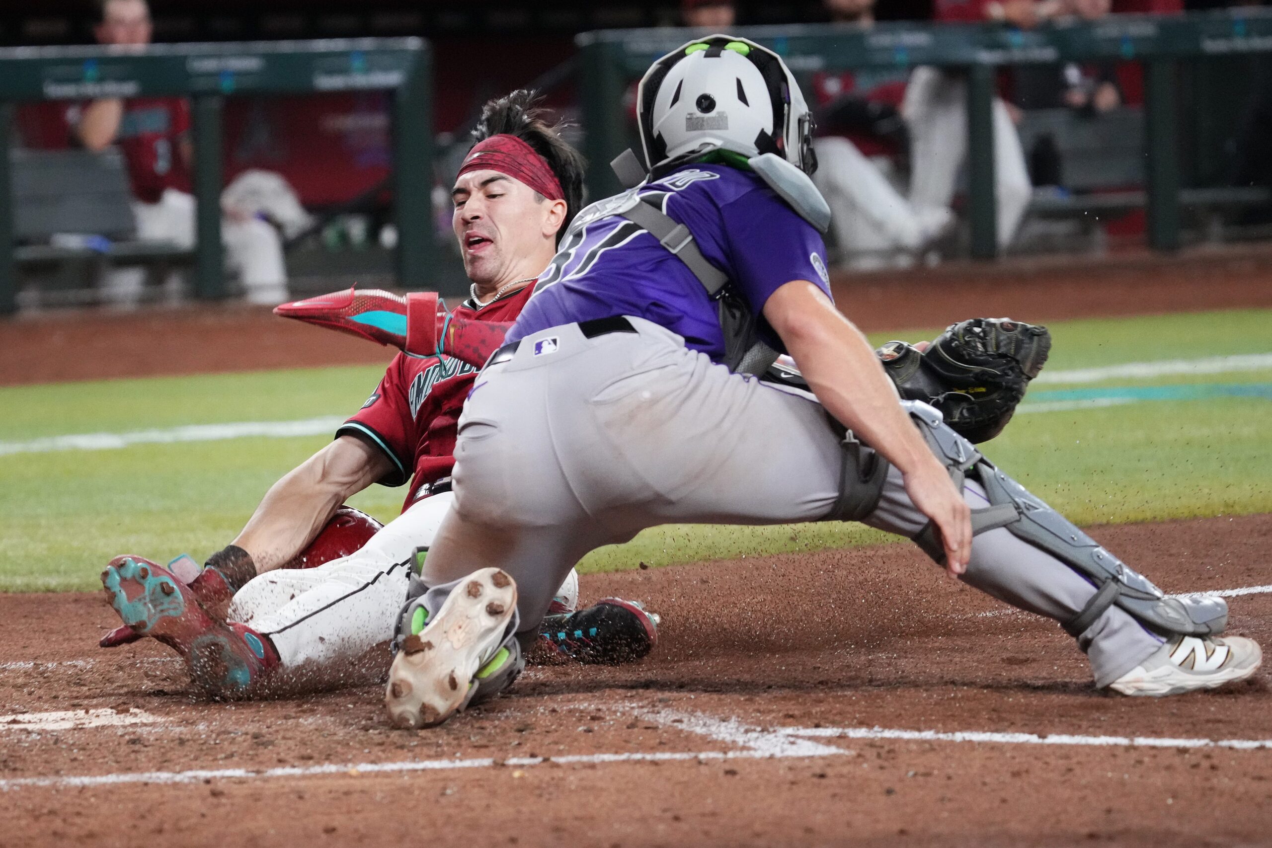 Arizona Diamondbacks baserunner Corbin Carroll (7) slides in to score a run past Colorado Rockies catcher Braxton Fulford (37) at Chase Field on Aug. 10, 2025.