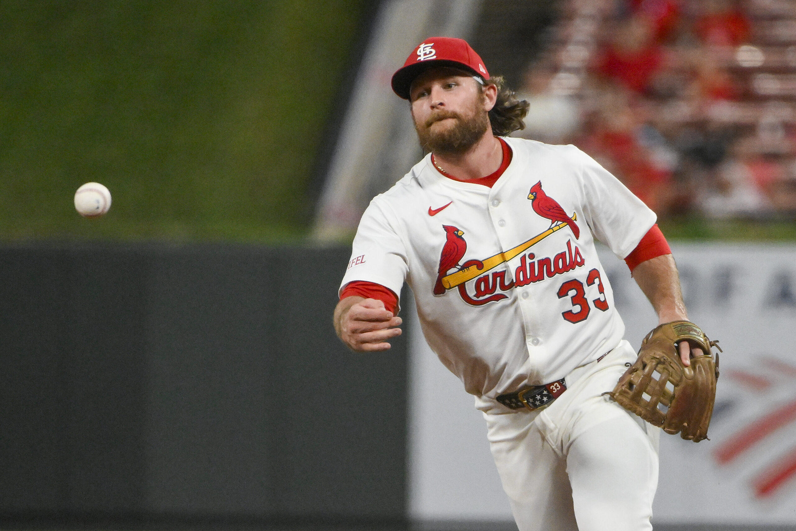 Aug 11, 2025; St. Louis, Missouri, USA;  St. Louis Cardinals second baseman Brendan Donovan (33) flips the ball to first base during the ninth inning against the Colorado Rockies at Busch Stadium. Mandatory Credit: Jeff Curry-Imagn Images