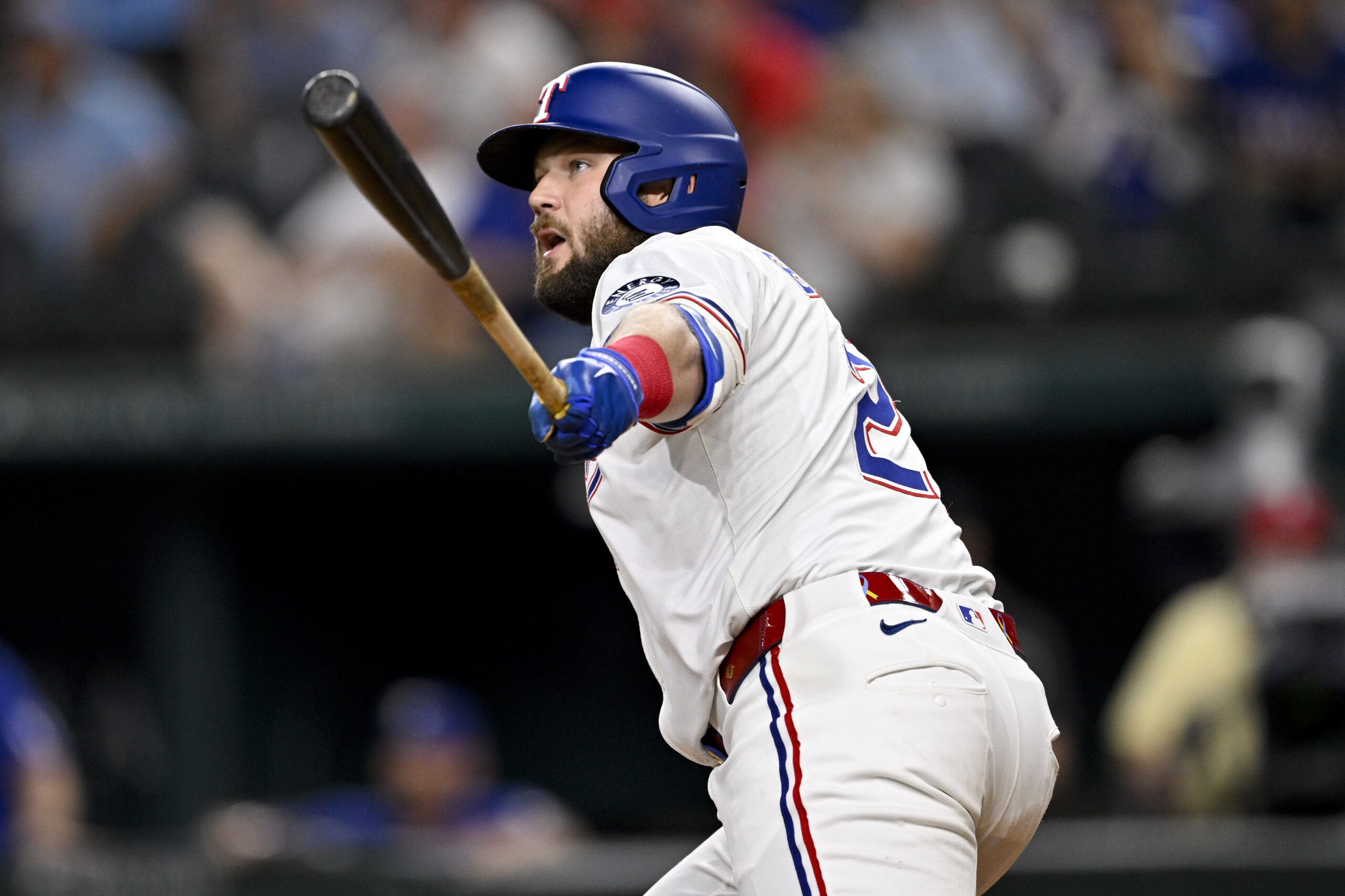 Aug 11, 2025; Arlington, Texas, USA; Texas Rangers pinch hitter Jake Burger (21) hits a single and drives in the game winning run against the Arizona Diamondbacks during the tenth inning at Globe Life Field. Mandatory Credit: Jerome Miron-Imagn Images