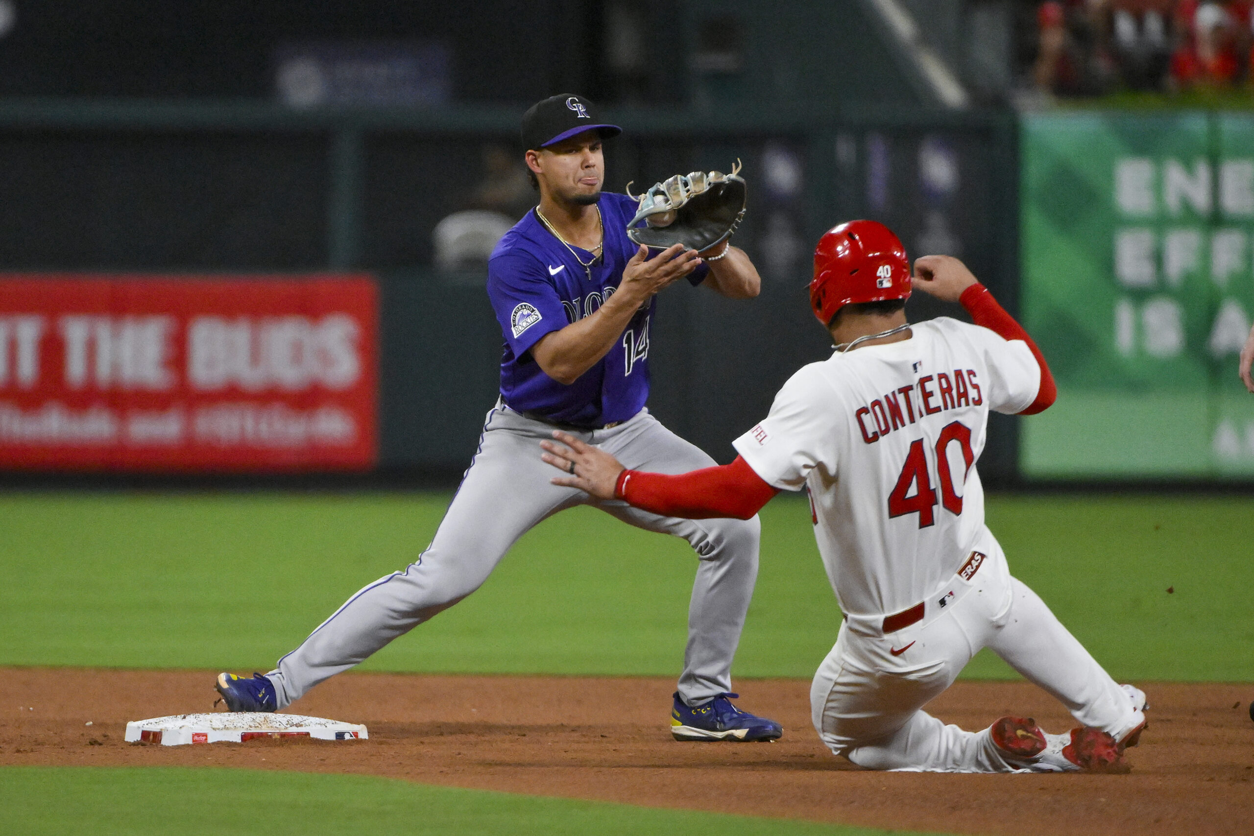 Aug 12, 2025; St. Louis, Missouri, USA;  Colorado Rockies shortstop Ezequiel Tovar (14) forces out St. Louis Cardinals first baseman Willson Contreras (40) during the fourth inning at Busch Stadium. Mandatory Credit: Jeff Curry-Imagn Images