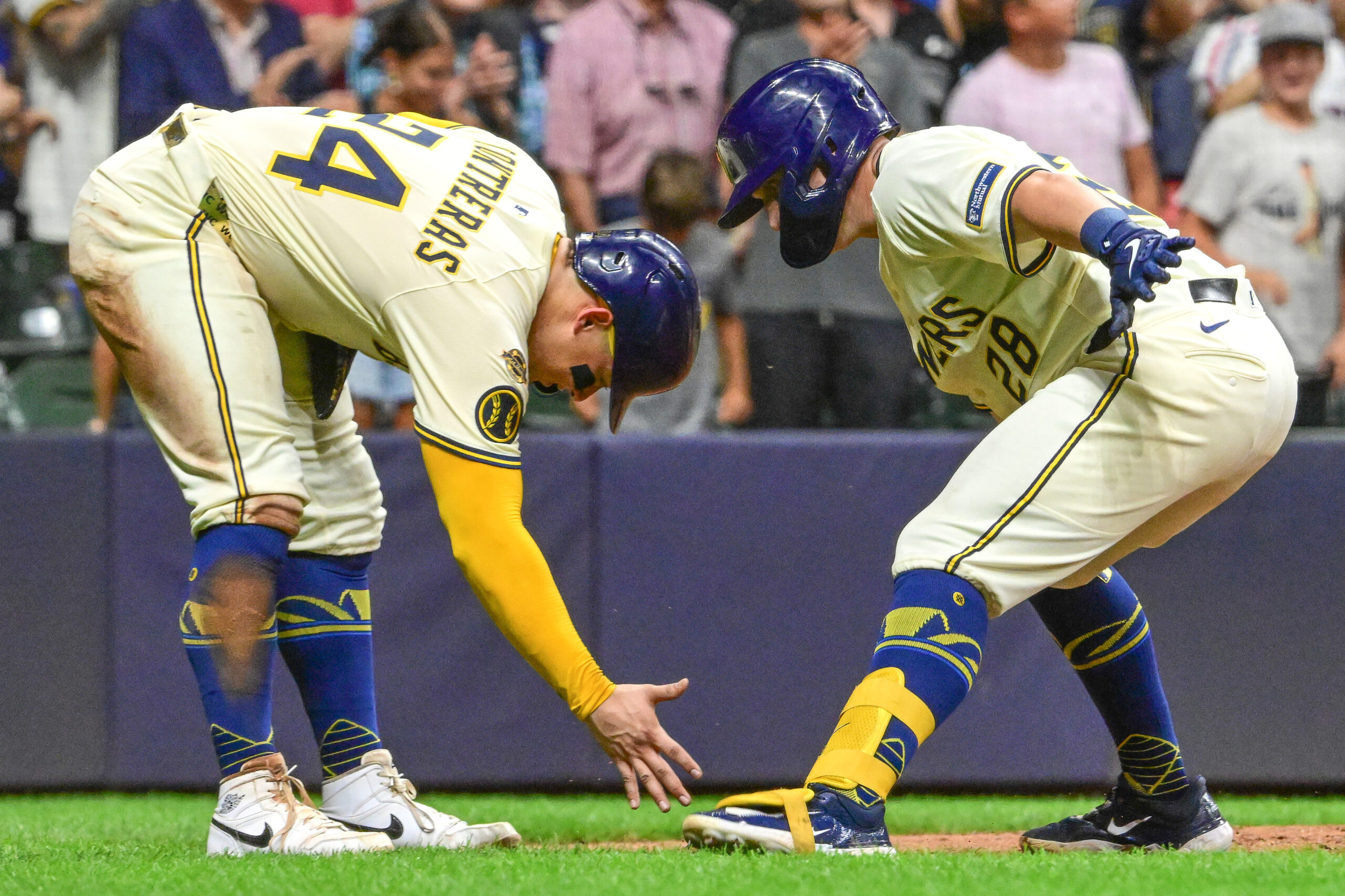 Aug 12, 2025; Milwaukee, Wisconsin, USA;  Milwaukee Brewers first baseman Andrew Vaughn (28) celebrates with  catcher William Contreras (24) after hitting a three run home run in the sixth inning at American Family Field. Mandatory Credit: Benny Sieu-Imagn Images