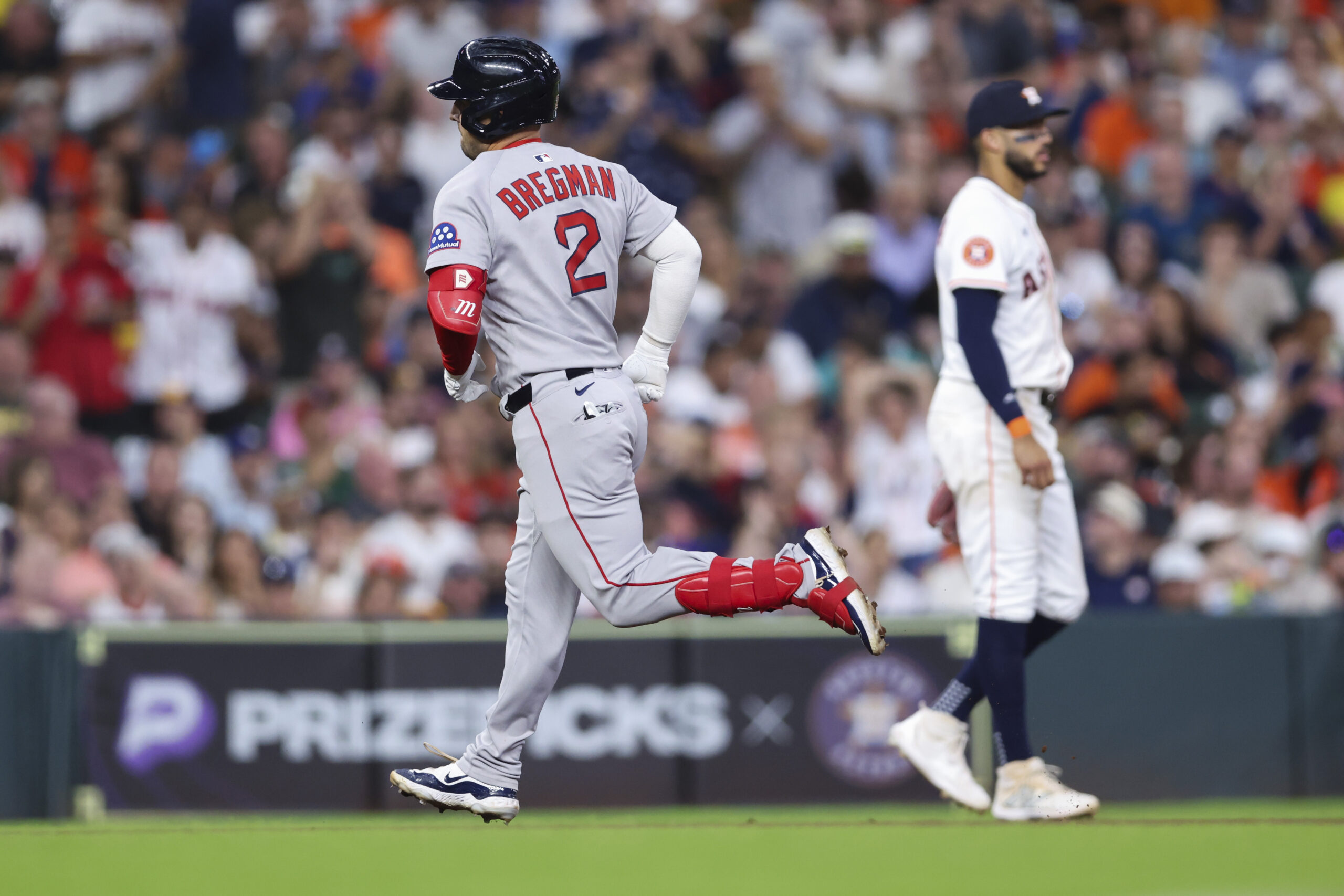 Aug 12, 2025; Houston, Texas, USA; Houston Astros third baseman Carlos Correa (1) reacts as Boston Red Sox third baseman Alex Bregman (2) rounds the bases after hitting a home run during the sixth inning at Daikin Park. Mandatory Credit: Troy Taormina-Imagn Images