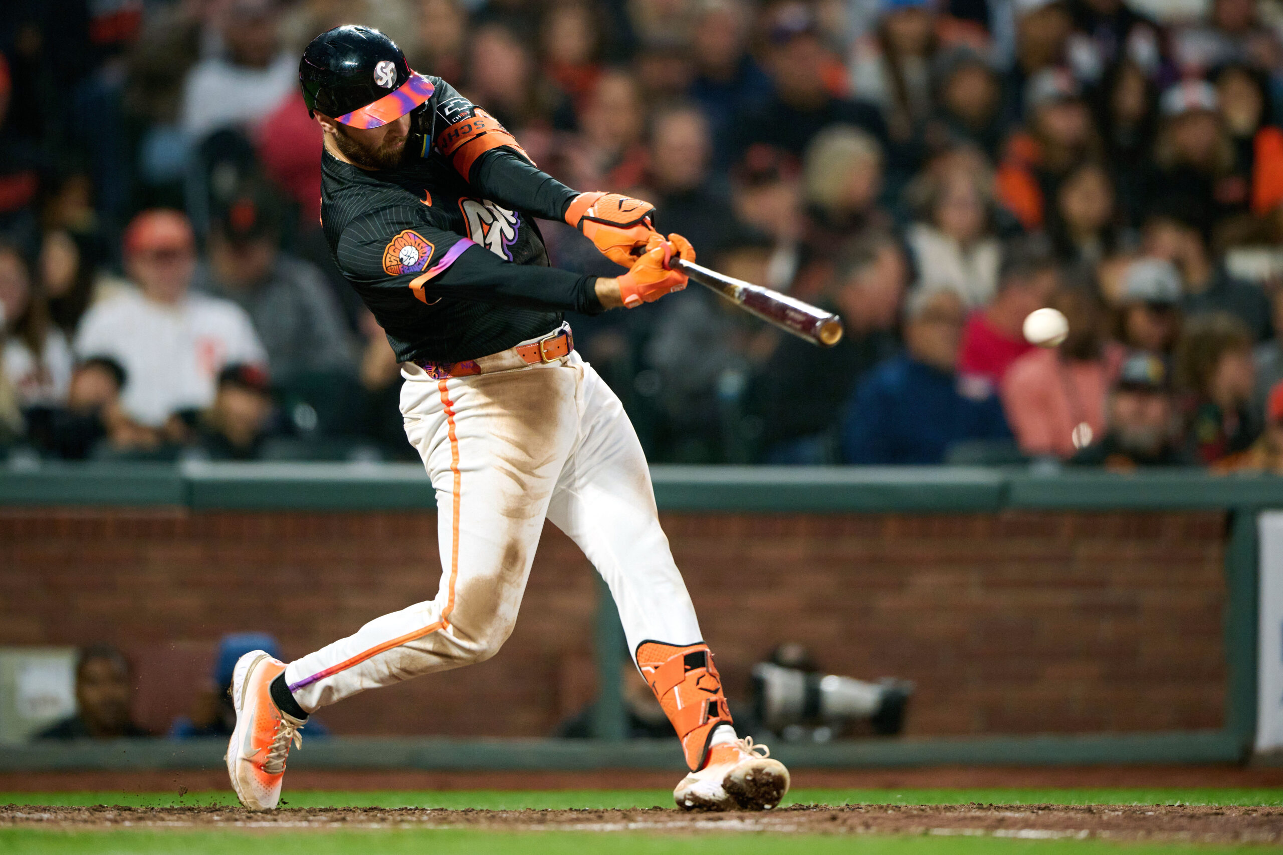 Aug 12, 2025; San Francisco, California, USA; San Francisco Giants second baseman Casey Schmitt (10) hits a single against the San Diego Padres during the fifth inning at Oracle Park. Mandatory Credit: Robert Edwards-Imagn Images