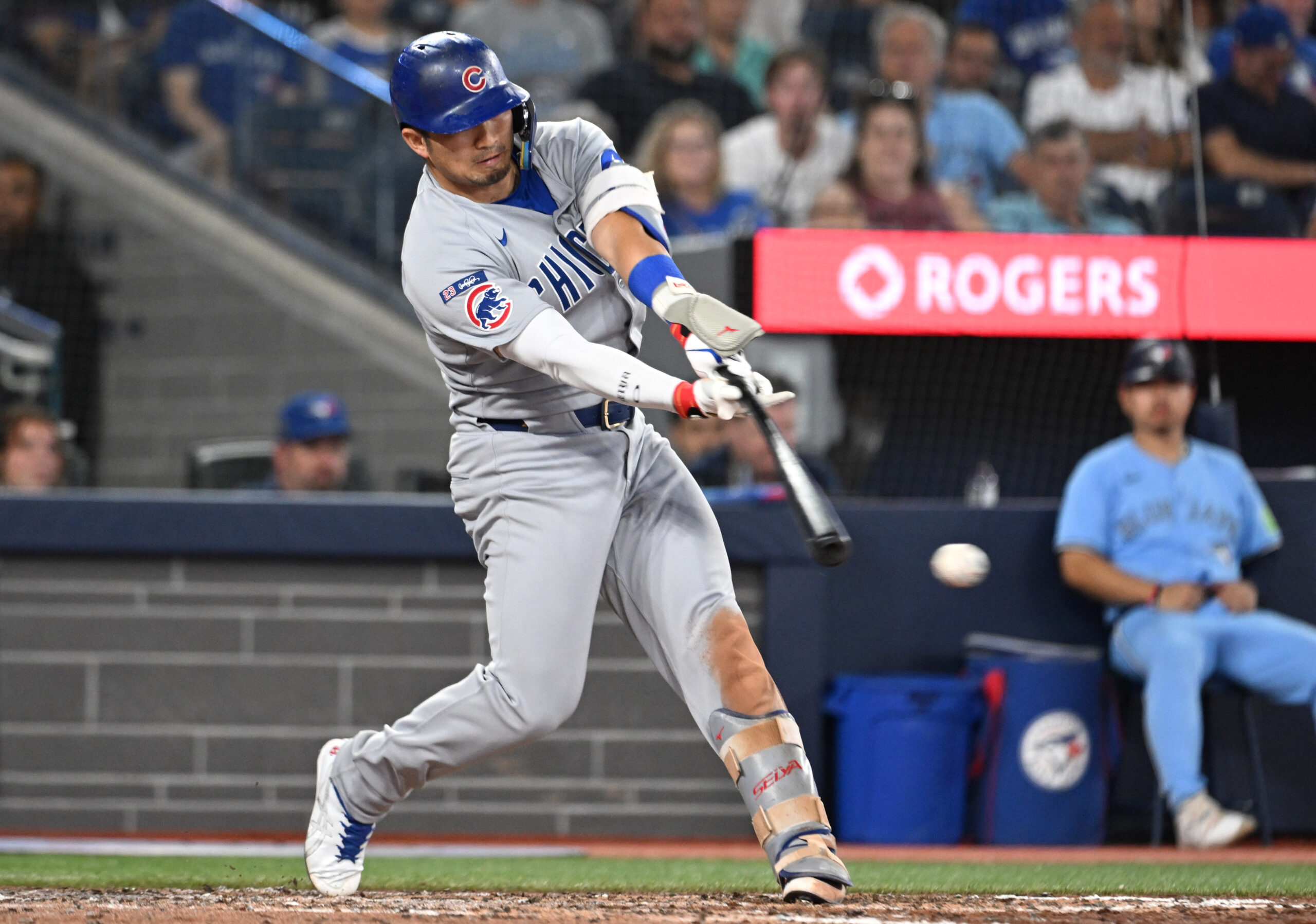 Aug 13, 2025; Toronto, Ontario, CAN;  Chicago Cubs designated hitter Seiya Suzuki (27) hits an RBI single against the Toronto Blue Jays in the eighth inning at Rogers Centre. Mandatory Credit: Dan Hamilton-Imagn Images