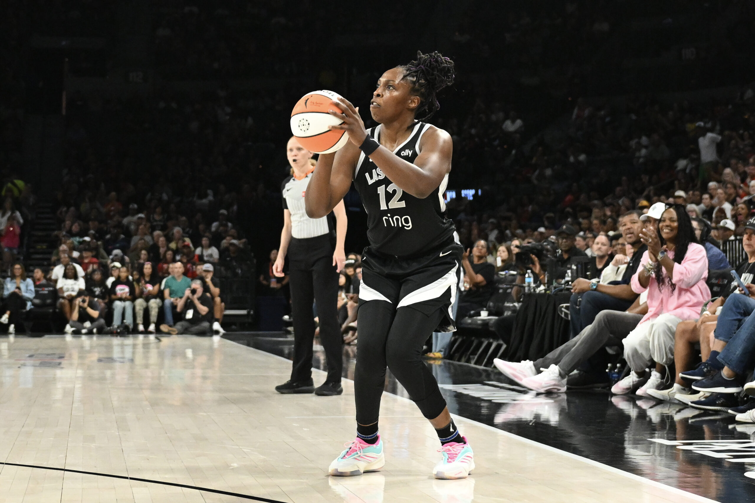 Aug 13, 2025; Las Vegas, Nevada, USA; Las Vegas Aces guard Chelsea Gray (12) shoots a 3-pointer against the New York Liberty during the second quarter of their game at Michelob Ultra Arena. Mandatory Credit: Candice Ward-Imagn Images