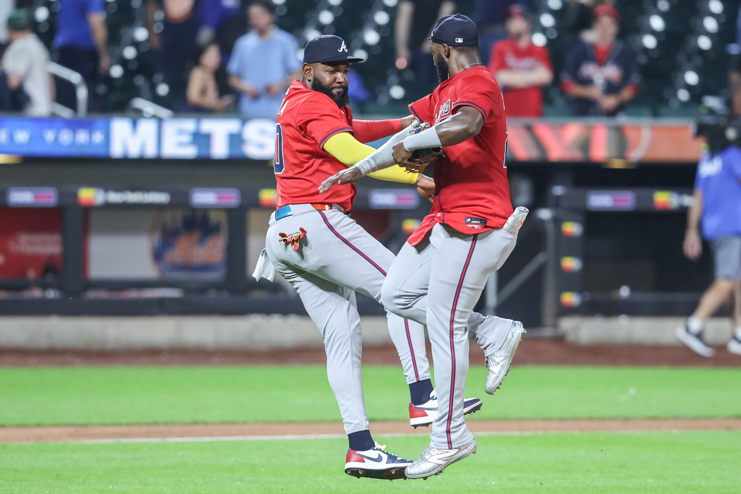 Aug 13, 2025; New York City, New York, USA; Atlanta Braves designated hitter Marcell Ozuna (20) and center fielder Michael Harris II (23) celebrate after defeating the New York Mets 11-6 at Citi Field. Mandatory Credit: Wendell Cruz-Imagn Images