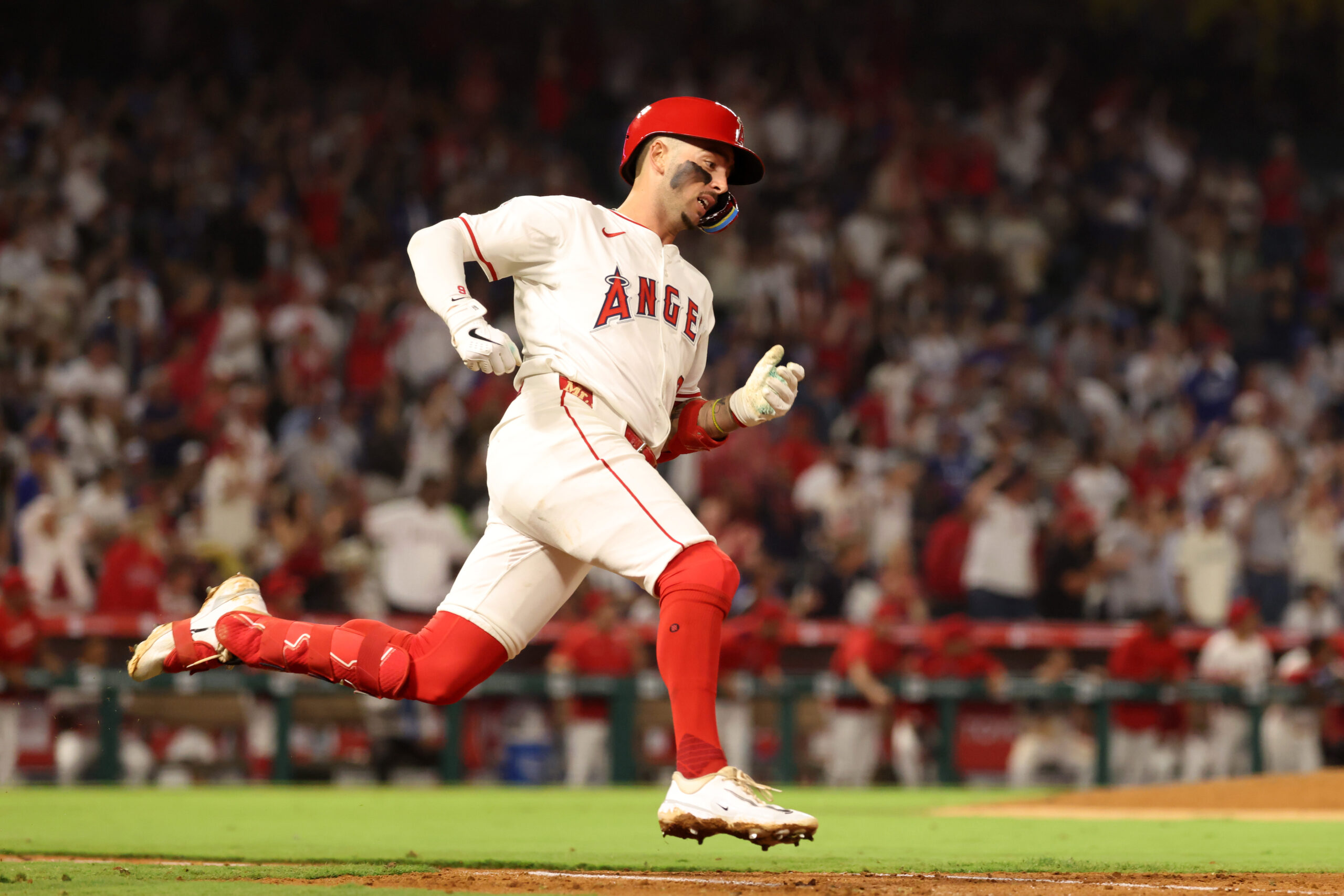 Aug 13, 2025; Anaheim, California, USA;  Los Angeles Angels shortstop Zach Neto (9) hits an RBI double during the fifth inning against the Los Angeles Dodgers at Angel Stadium. Mandatory Credit: Kiyoshi Mio-Imagn Images