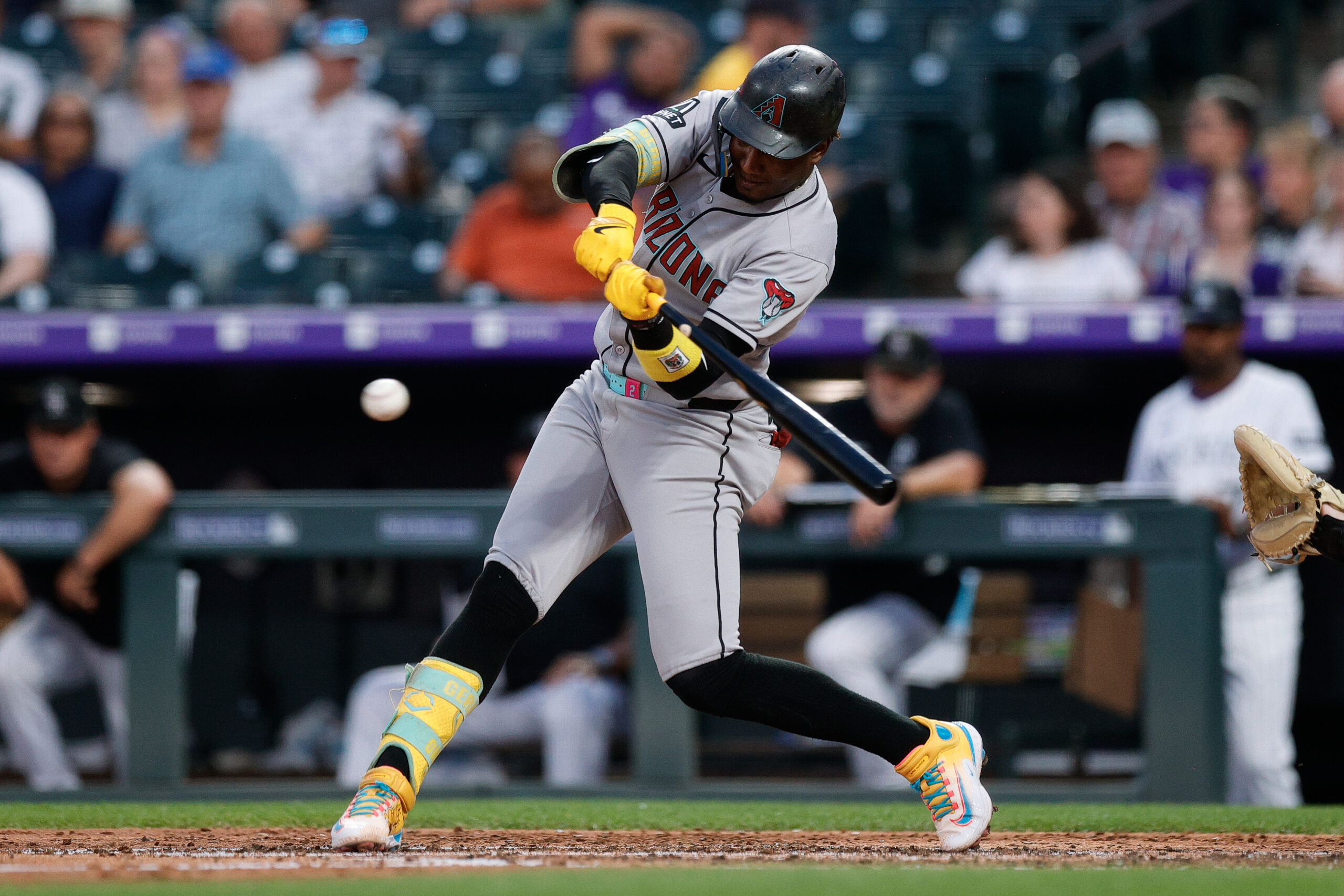 Aug 14, 2025; Denver, Colorado, USA; Arizona Diamondbacks shortstop Geraldo Perdomo (2) hits a single in the fourth inning against the Colorado Rockies at Coors Field. Mandatory Credit: Isaiah J. Downing-Imagn Images