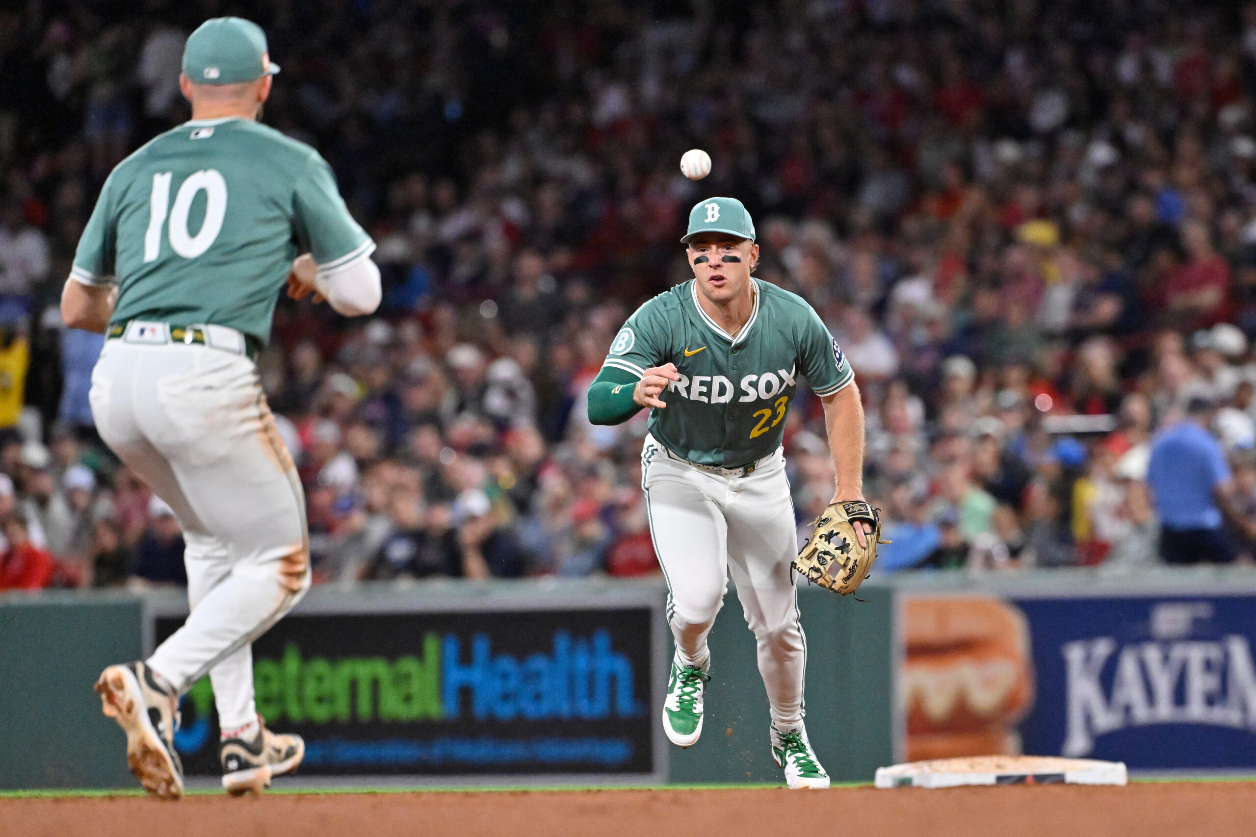 Aug 15, 2025; Boston, Massachusetts, USA; Boston Red Sox second baseman Romy Gonzalez (23) tosses the ball to shortstop Trevor Story (10) for a double play against the Miami Marlins during the seventh inning at Fenway Park. Mandatory Credit: Eric Canha-Imagn Images