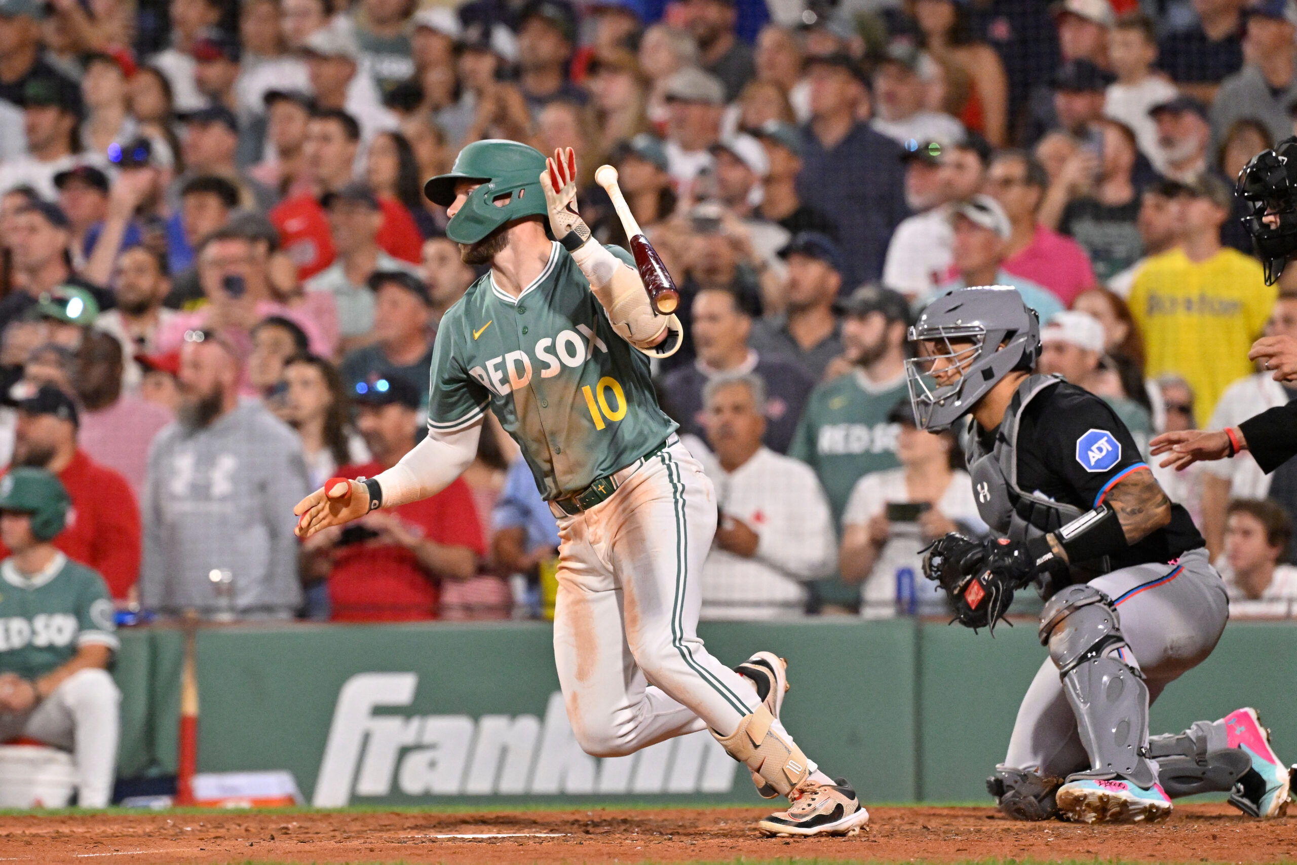 Aug 15, 2025; Boston, Massachusetts, USA; Boston Red Sox shortstop Trevor Story (10) hits a walk-off RBI against the Miami Marlins during the ninth inning at Fenway Park. Mandatory Credit: Eric Canha-Imagn Images