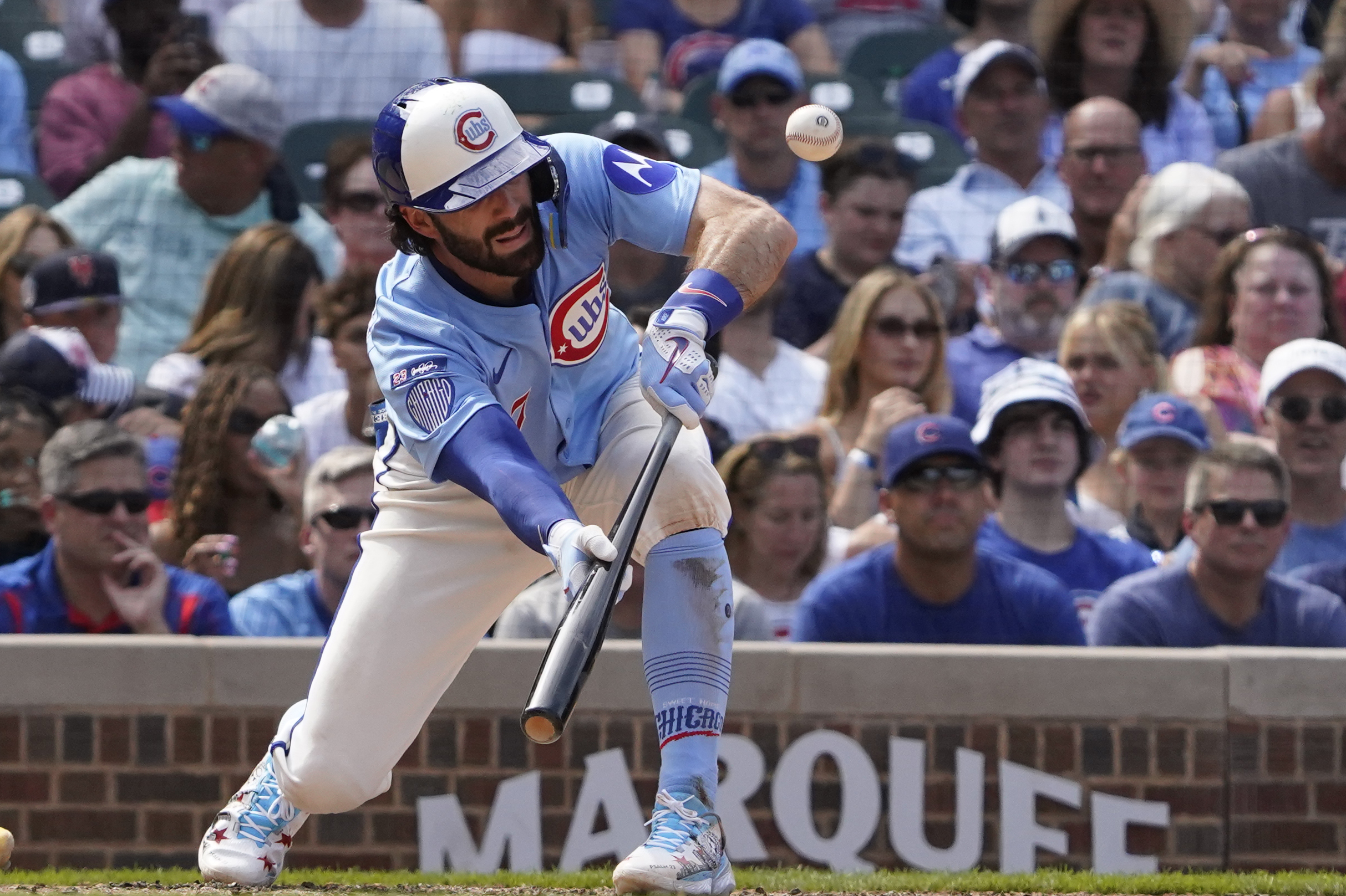Aug 15, 2025; Chicago, Illinois, USA; Chicago Cubs shortstop Dansby Swanson (7) lays down a sacrifice bunt against the Pittsburgh Pirates during the seventh inning at Wrigley Field. Mandatory Credit: David Banks-Imagn Images
