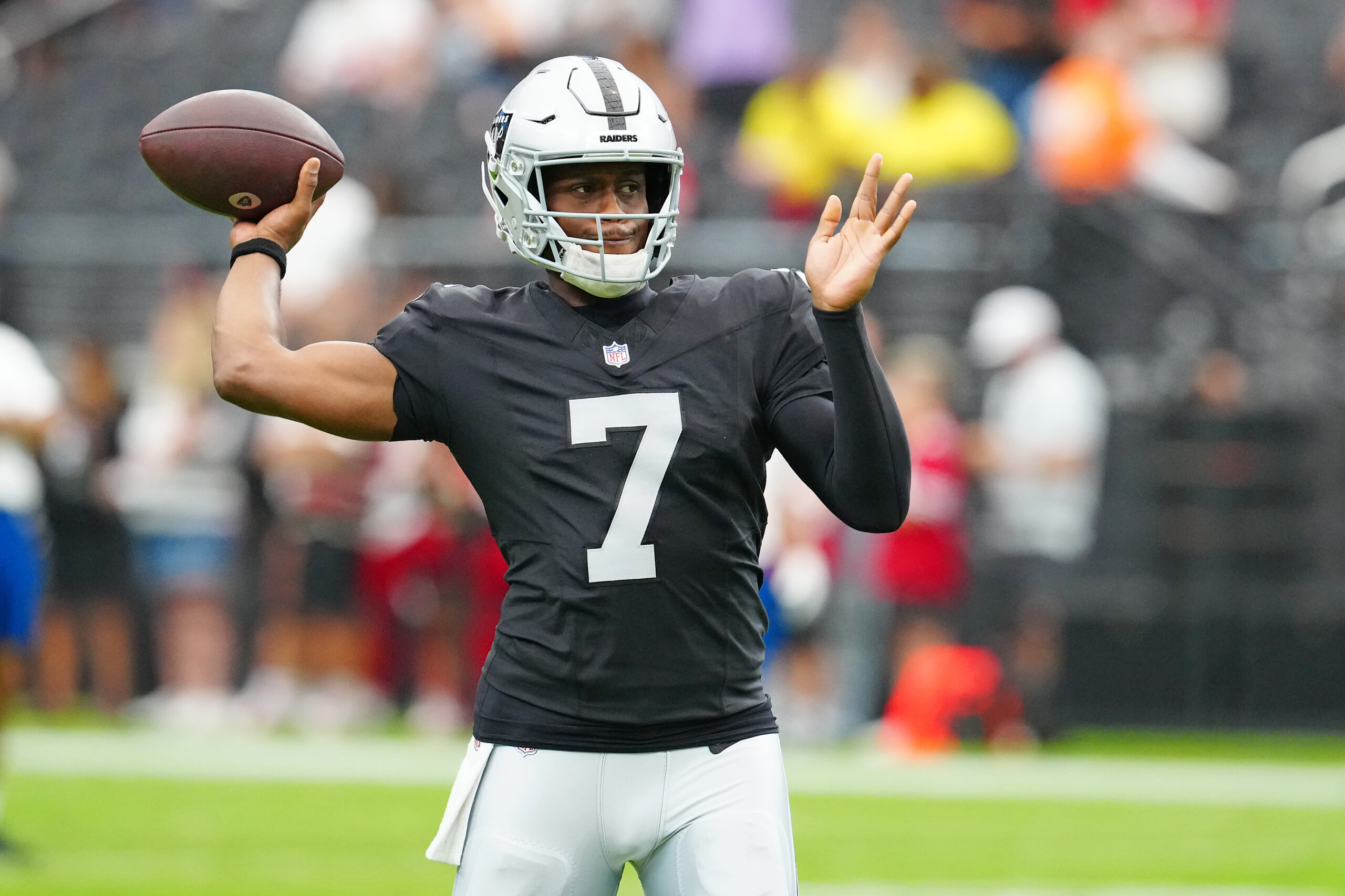 Aug 16, 2025; Paradise, Nevada, USA; Las Vegas Raiders quarterback Geno Smith (7) warms up before a preseason game against the San Francisco 49ers at Allegiant Stadium. Mandatory Credit: Stephen R. Sylvanie-Imagn Images
