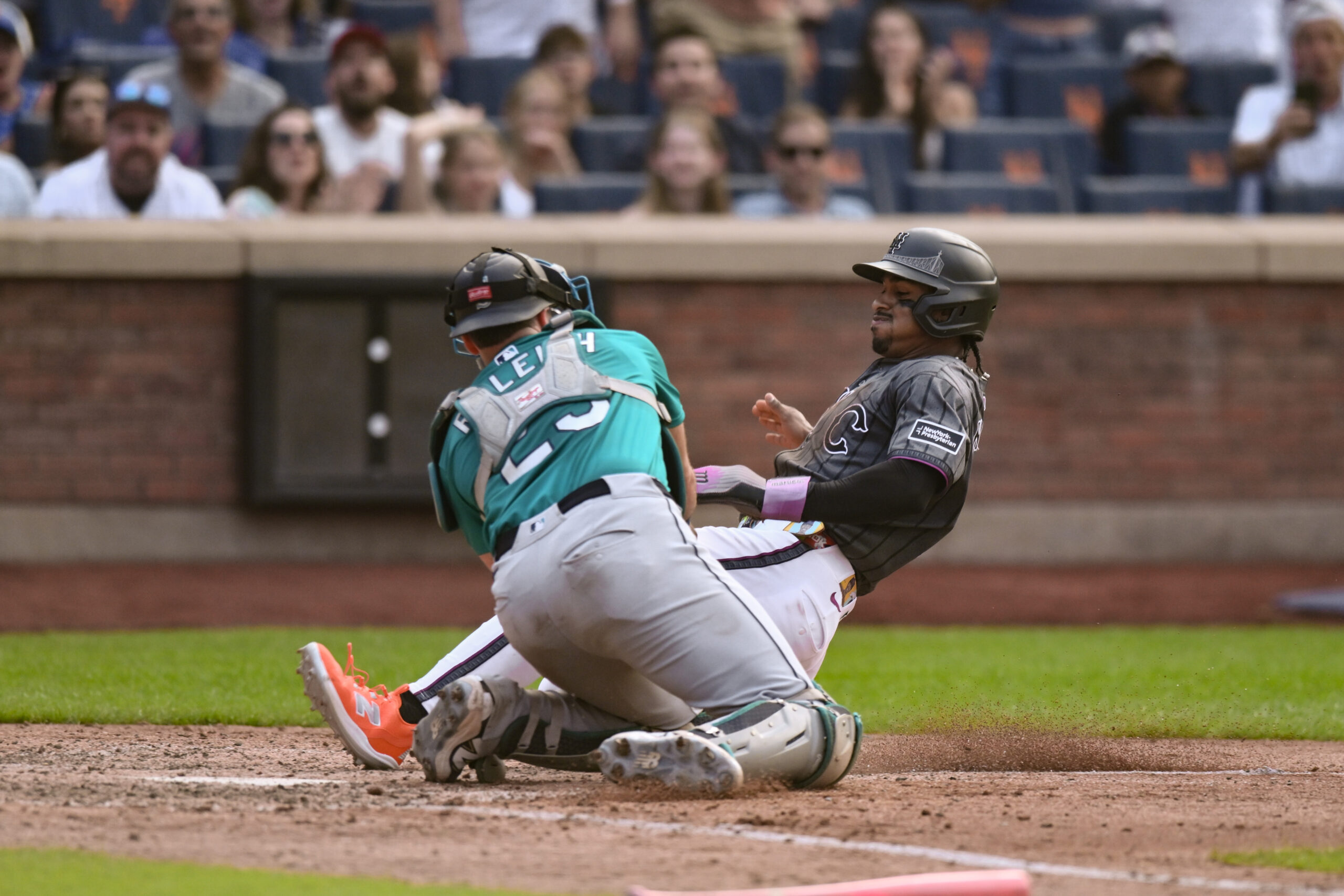 Aug 16, 2025; New York City, New York, USA; New York Mets shortstop Francisco Lindor (12) is tagged out at home plate by Seattle Mariners catcher Cal Raleigh (29) during the seventh inning at Citi Field. Mandatory Credit: John Jones-Imagn Images