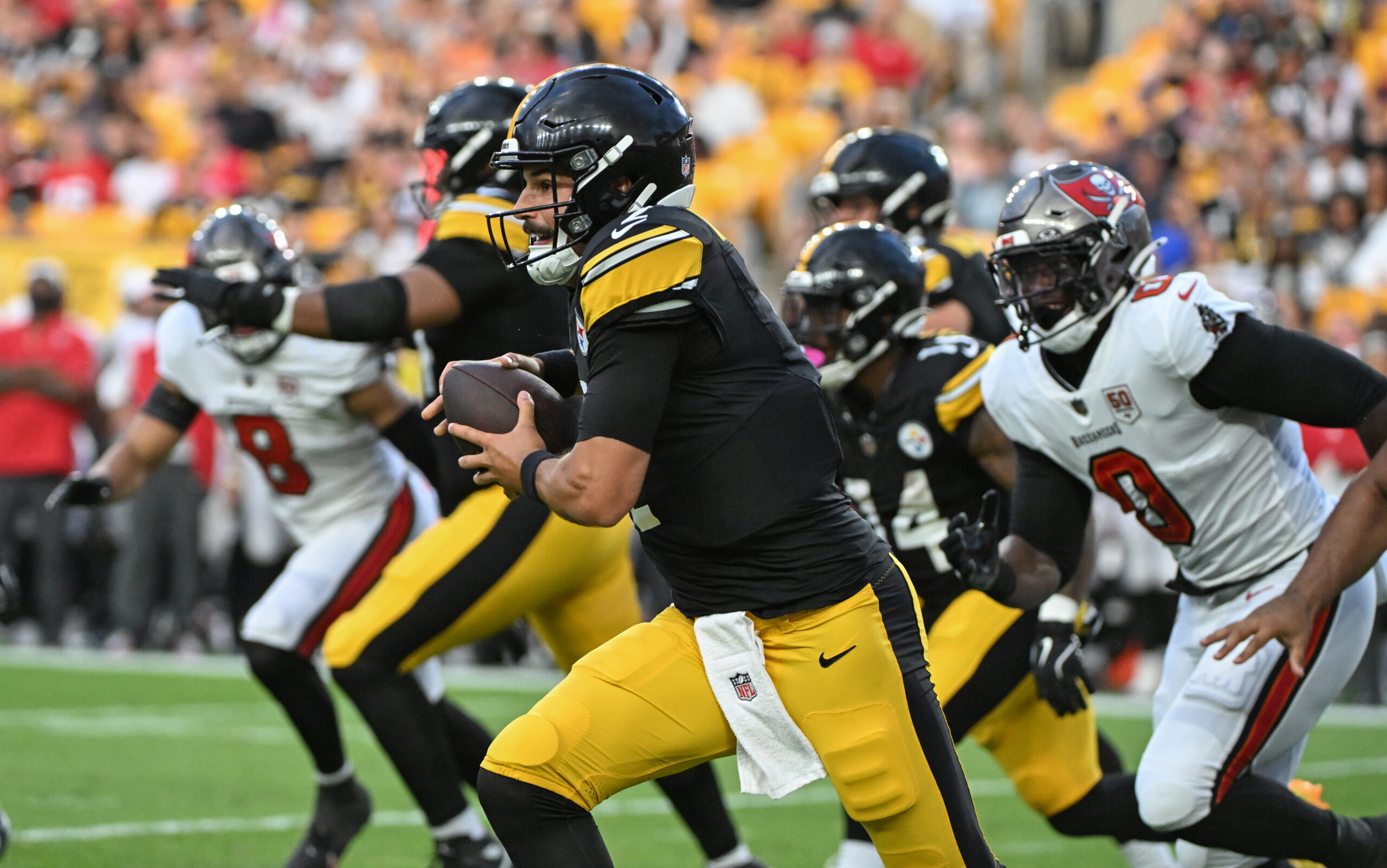 Aug 16, 2025; Pittsburgh, Pennsylvania, USA; Pittsburgh Steelers quarterback Mason Rudolph (2) scrambles away from Tampa Bay Buccaneers linebacker Yaya Diaby (0) during the first quarter at Acrisure Stadium. Mandatory Credit: Barry Reeger-Imagn Images