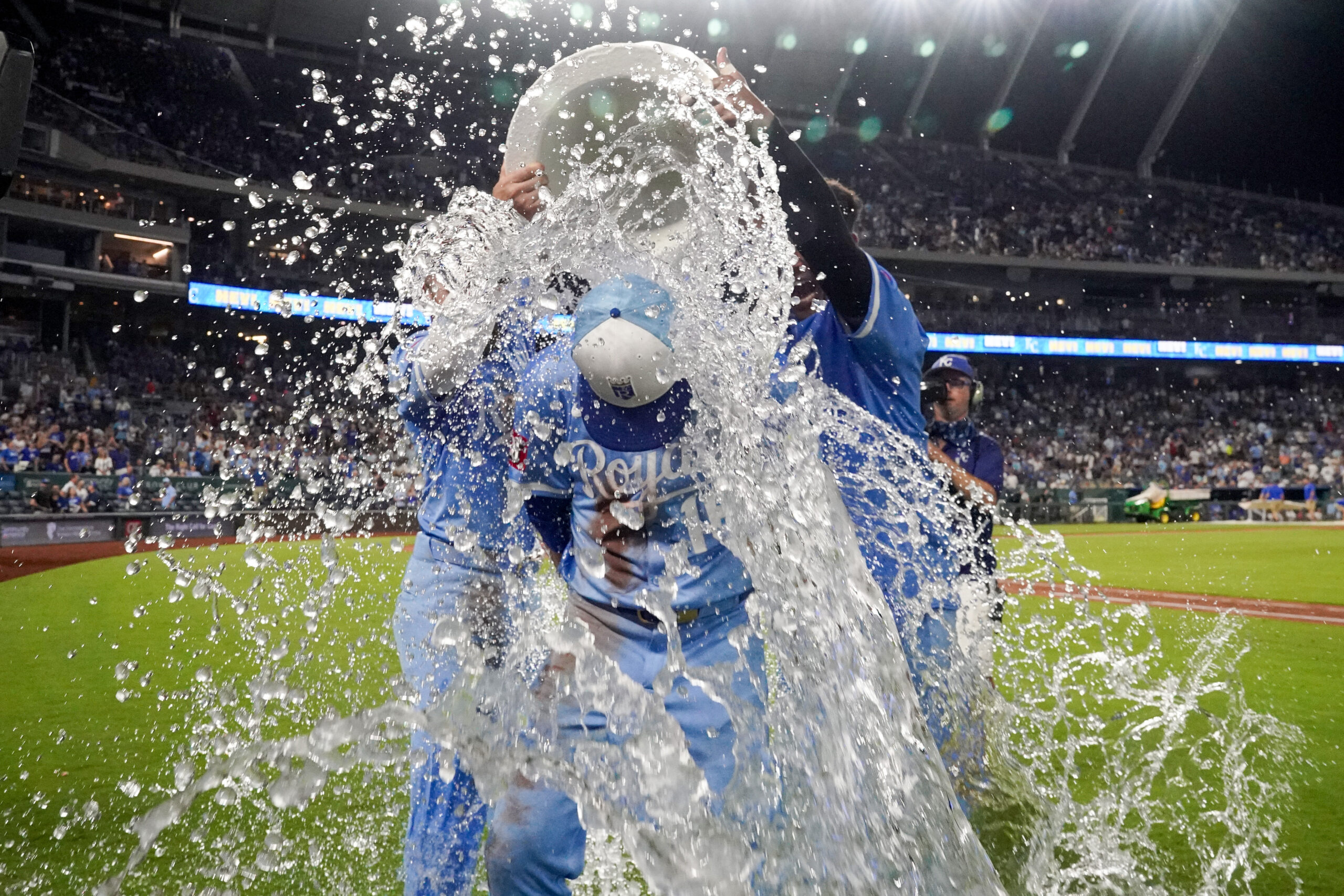 Aug 16, 2025; Kansas City, Missouri, USA; Kansas City Royals right fielder John Rave (16) is doused by center fielder Kyle Isbel (28) and catcher Salvador Perez (13) after the win over the Chicago White Sox at Kauffman Stadium. Mandatory Credit: Denny Medley-Imagn Images
