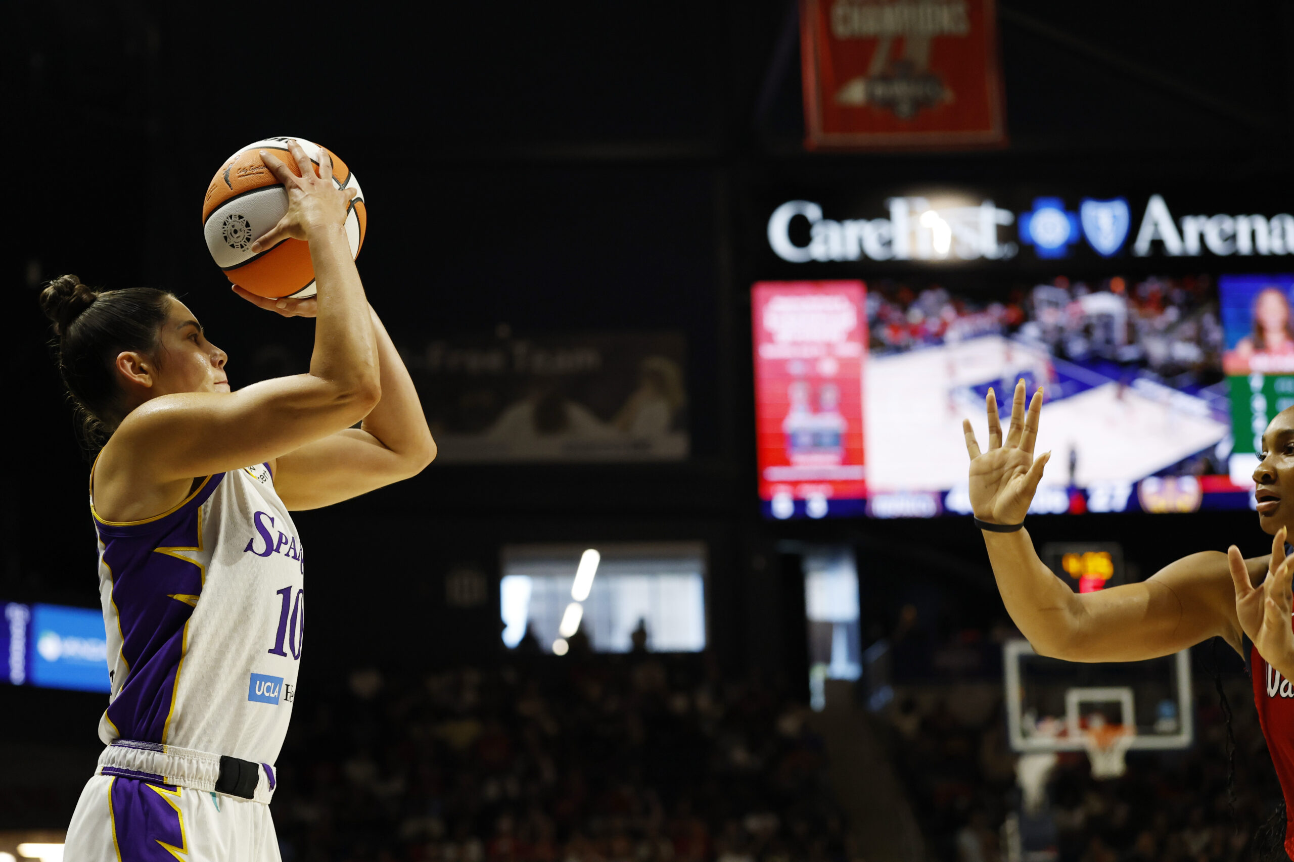 Aug 17, 2025; Washington, District of Columbia, USA; Los Angeles Sparks guard Kelsey Plum (10) shoots the ball as Washington Mystics forward Kiki Iriafen (44) defends in the first half at CareFirst Arena. Mandatory Credit: Geoff Burke-Imagn Images