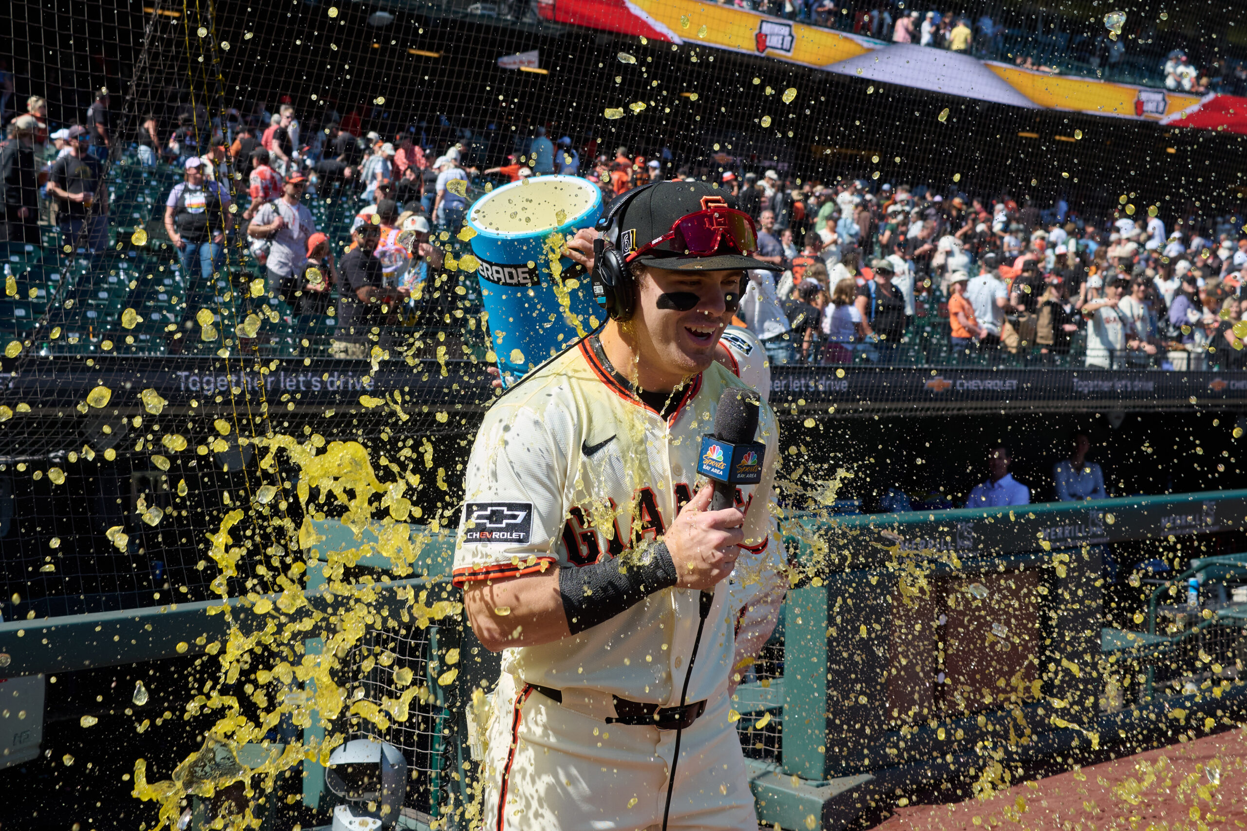 Aug 17, 2025; San Francisco, California, USA; San Francisco Giants shortstop Willy Adames (2) (obscured) dumps a cooler of sports drink over right fielder Drew Gilbert (61) to celebrate the Giants defeat of the Tampa Bay Rays in the ninth inning at Oracle Park. Mandatory Credit: Robert Edwards-Imagn Images