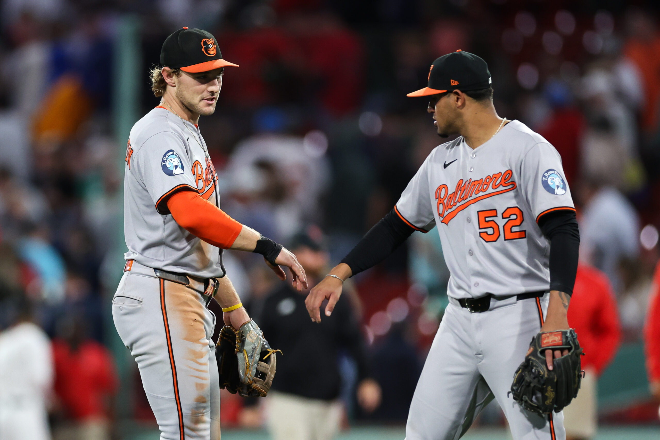 Aug 18, 2025; Boston, Massachusetts, USA; Baltimore Orioles shortstop Gunnar Henderson (2) and Baltimore Orioles shortstop Luis Vazquez (52) celebrate after defeating the Boston Red Sox at Fenway Park. Mandatory Credit: Paul Rutherford-Imagn Images