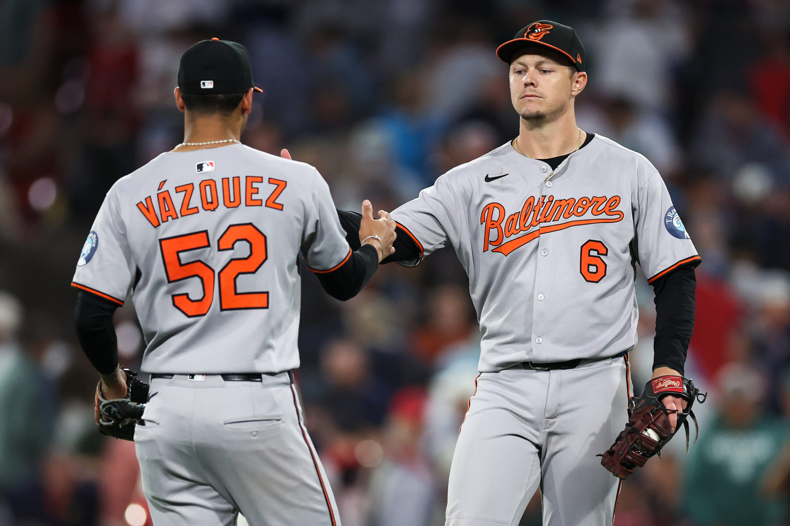 Aug 18, 2025; Boston, Massachusetts, USA; Baltimore Orioles first baseman Ryan Mountcastle (6) and Baltimore Orioles shortstop Luis Vazquez (52) celebrate after defeating the Boston Red Sox at Fenway Park. Mandatory Credit: Paul Rutherford-Imagn Images