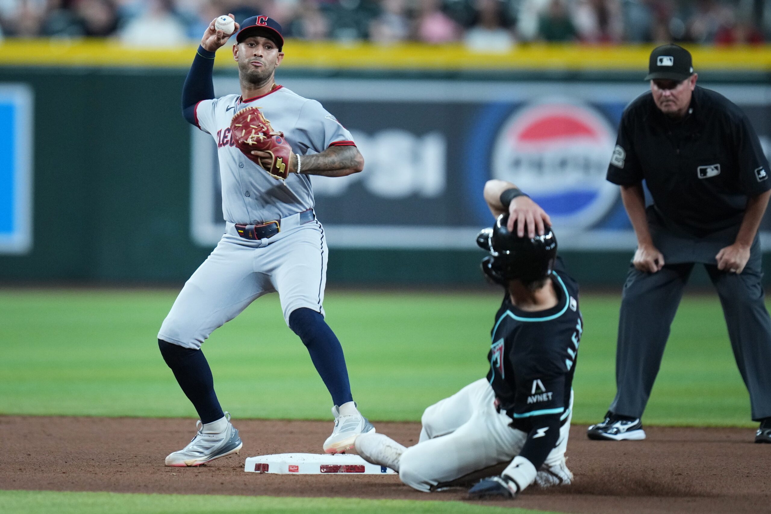Arizona Diamondbacks baserunner Blaze Alexander (9) is forced out at second base as Cleveland Guardians infielder Brayan Rocchio (4) attempts to turn the double play at Chase Field on Aug. 19, 2025.