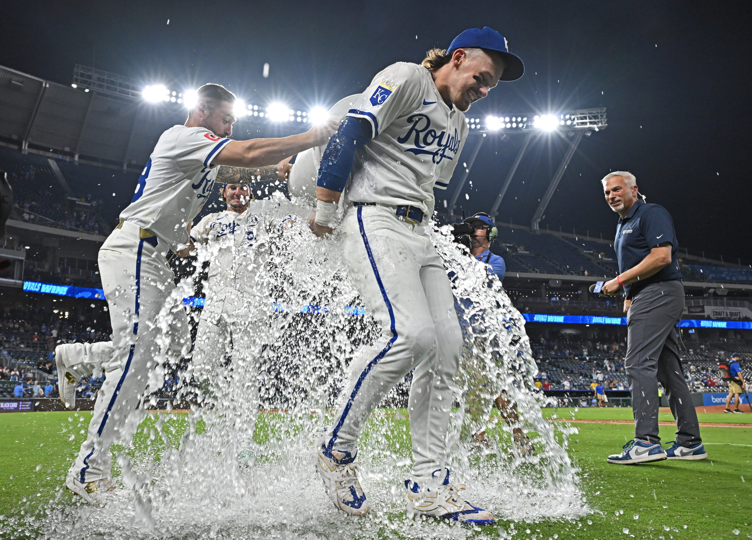 Aug 19, 2025; Kansas City, Missouri, USA;  Kansas City Royals teammates ice down shortstop Bobby Witt Jr. (7) after beating the Texas Rangers at Kauffman Stadium. Mandatory Credit: Peter Aiken-Imagn Images
