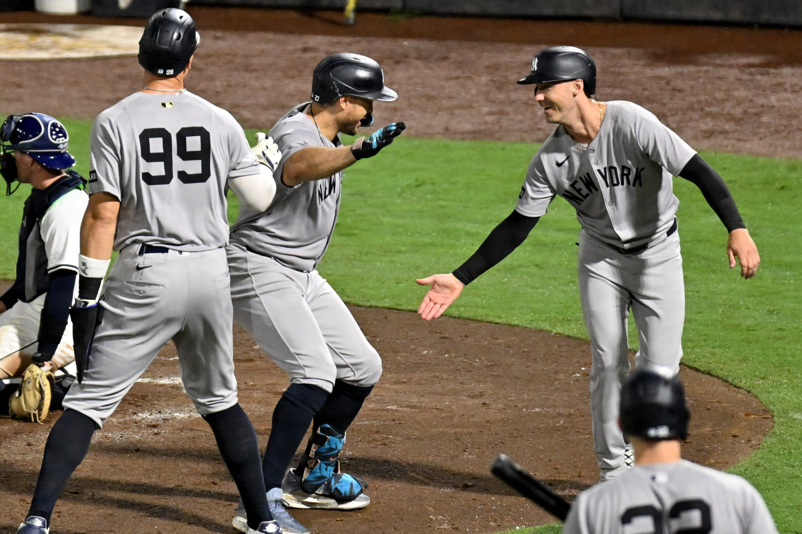 Aug 19, 2025; St. Petersburg, Florida, USA; New York Yankees right fielder fielder Giancarlo Stanton (27) celebrates with left fielder Cody Bellinger (35) and designated hitter Aaron Judge (99) after hitting a three run home run in the fourth inning against the Tampa Bay Rays at George M. Steinbrenner Field. Mandatory Credit: Jonathan Dyer-Imagn Images