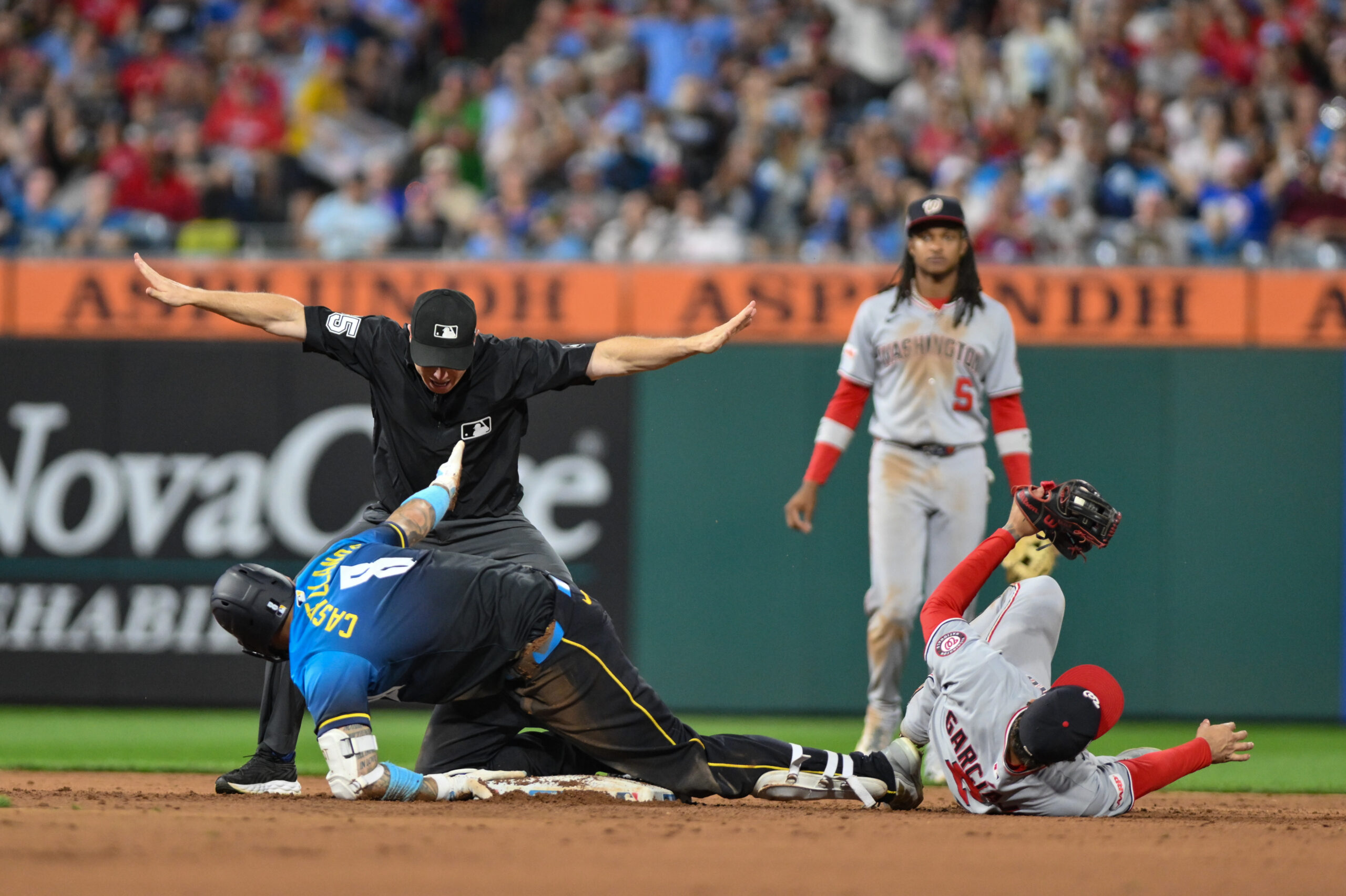 Aug 22, 2025; Philadelphia, Pennsylvania, USA; Philadelphia Phillies outfielder Nick Castellanos (8) slides safely into second base with a double against Washington Nationals second baseman Luis García Jr. (2) during the sixth inning at Citizens Bank Park. Mandatory Credit: John Jones-Imagn Images