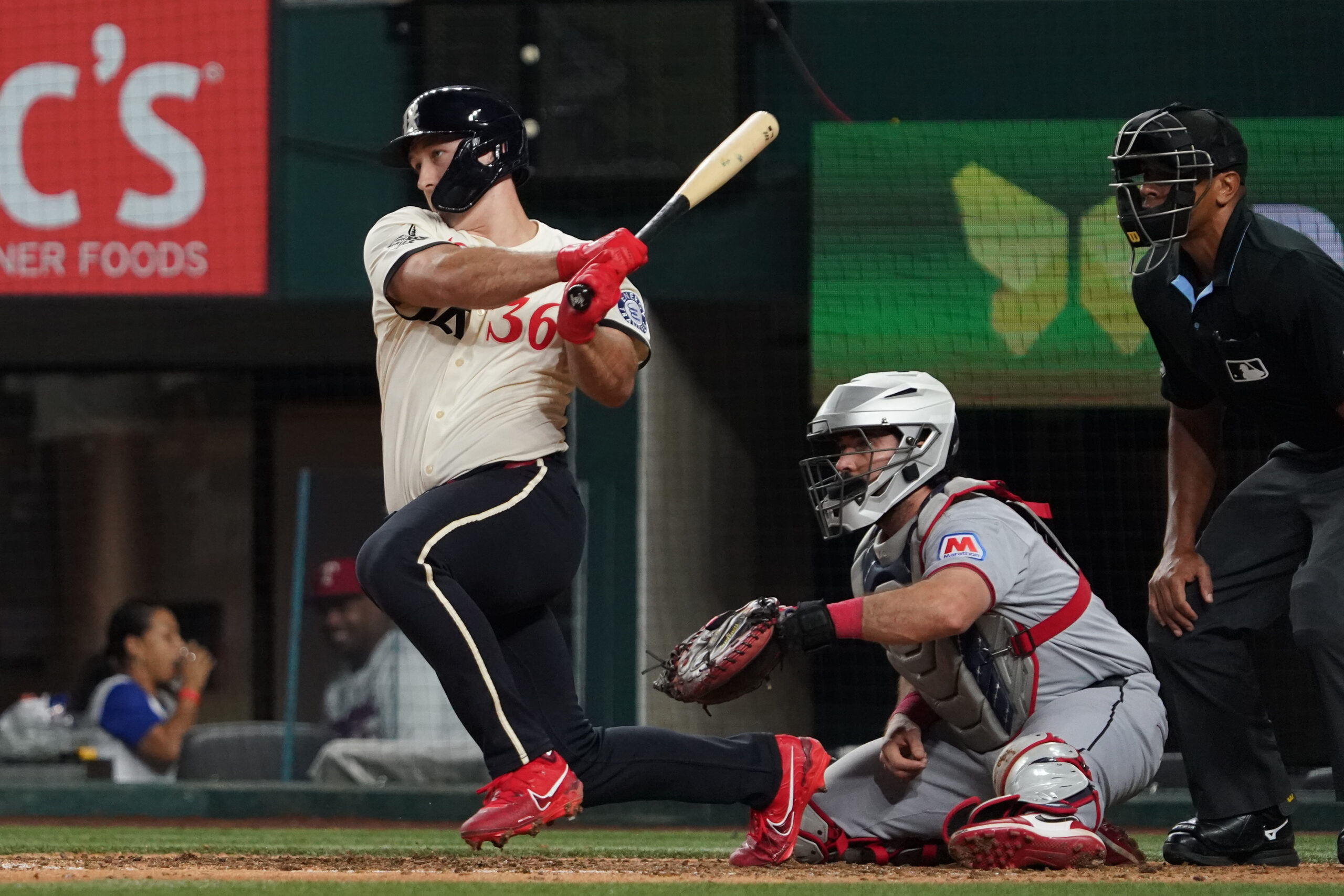 Aug 22, 2025; Arlington, Texas, USA; Texas Rangers left fielder Wyatt Langford (36) hits a double during the ninth inning against the Cleveland Guardians at Globe Life Field. Mandatory Credit: Raymond Carlin III-Imagn Images