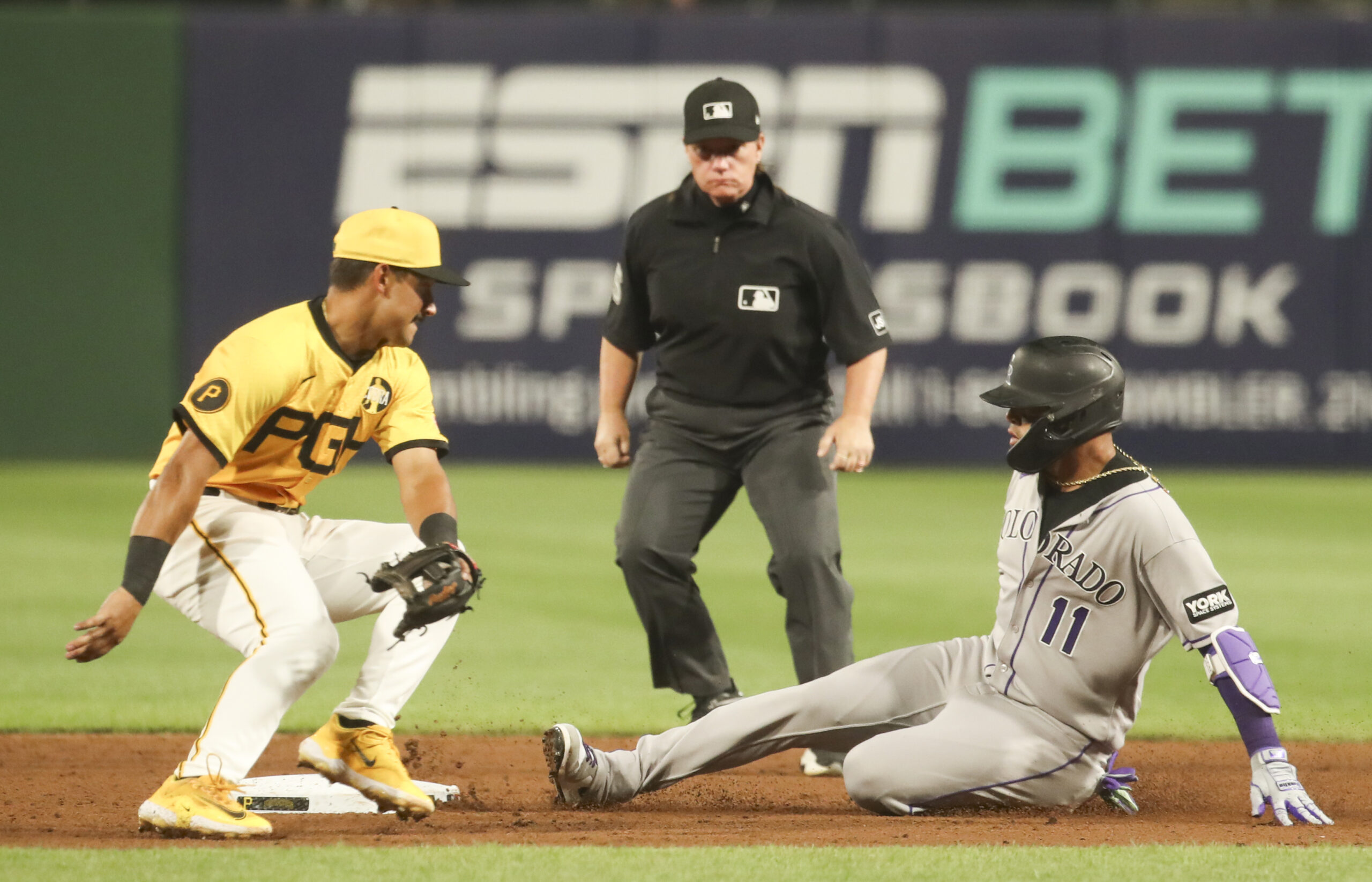 Aug 22, 2025; Pittsburgh, Pennsylvania, USA;  Colorado Rockies shortstop Orlando Arcia (11) slides safely into second base as Pittsburgh Pirates second baseman Nick Gonzales (39) attempts a tag during the sixth inning at PNC Park. Mandatory Credit: Charles LeClaire-Imagn Images