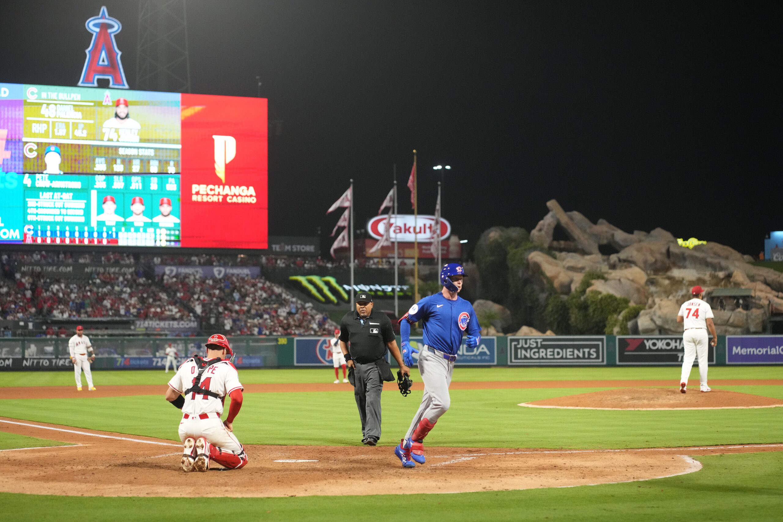 Aug 22, 2025; Anaheim, California, USA; Chicago Cubs center fielder Pete Crow-Armstrong (4) crosses home plate after hitting a home run in the ninth inning as Los Angeles Angels relief pitcher Kenley Jansen (74) and catcher Logan O'Hoppe (14) and home plate umpire Adrian Johnson watch at Angel Stadium. Mandatory Credit: Kirby Lee-Imagn Images