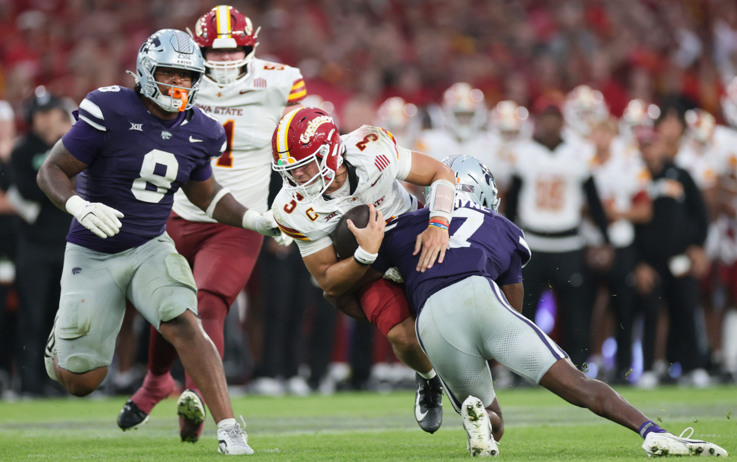 Aug 23, 2025; Dublin, IRELAND; Iowa State quarterback Rocco Becht is tackled by VJ Payne of Kansas State during the Aer Lingus Classic between Iowa State and Kansas State at Aviva Stadium. Mandatory Credit: Laszlo Geczo/INPHO via Imagn Images