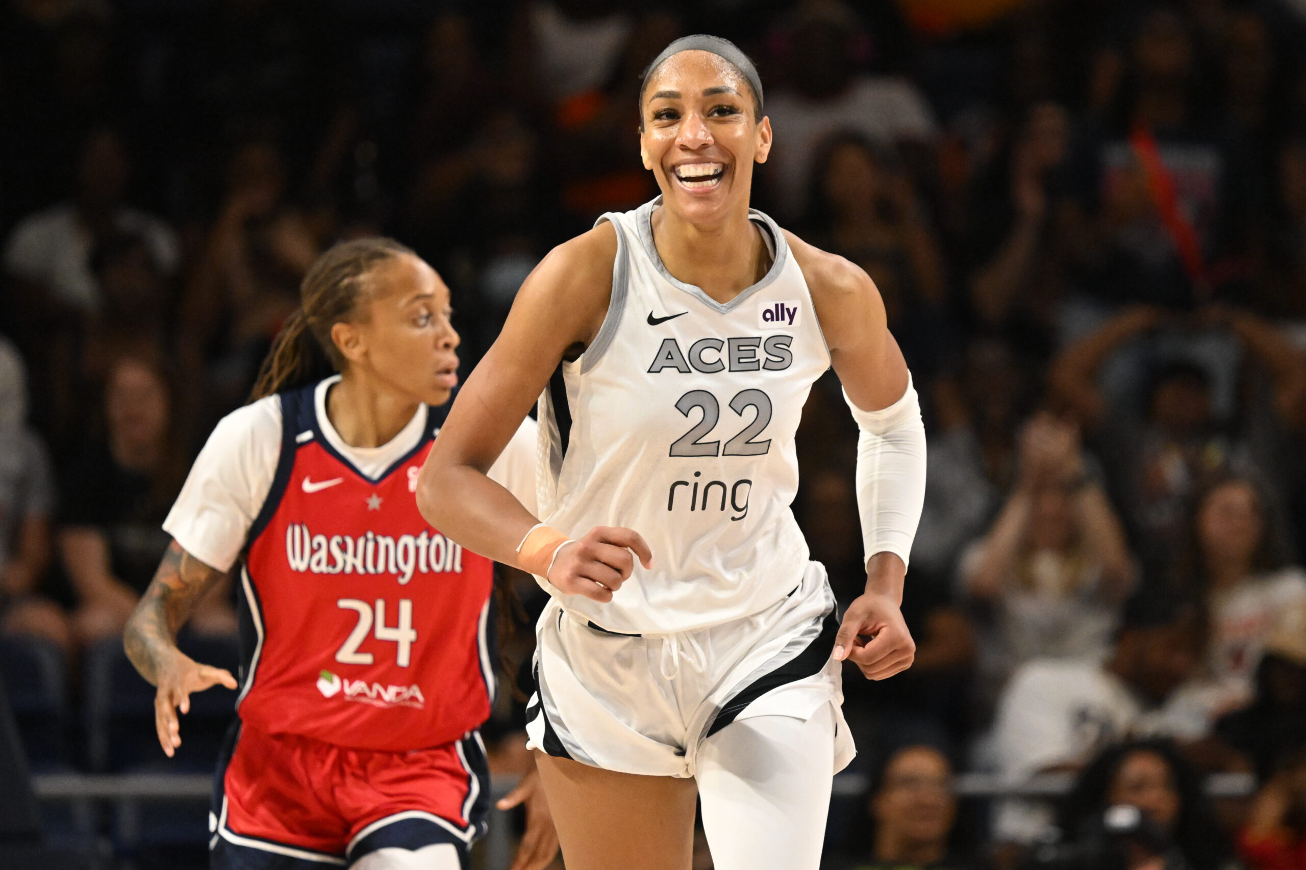Aug 23, 2025; Washington, District of Columbia, USA;  Las Vegas Aces center A'ja Wilson (22) is all smiles after a basket against the Washington Mystics during the fourth quarter at CareFirst Arena. Mandatory Credit: Rafael Suanes-Imagn Images