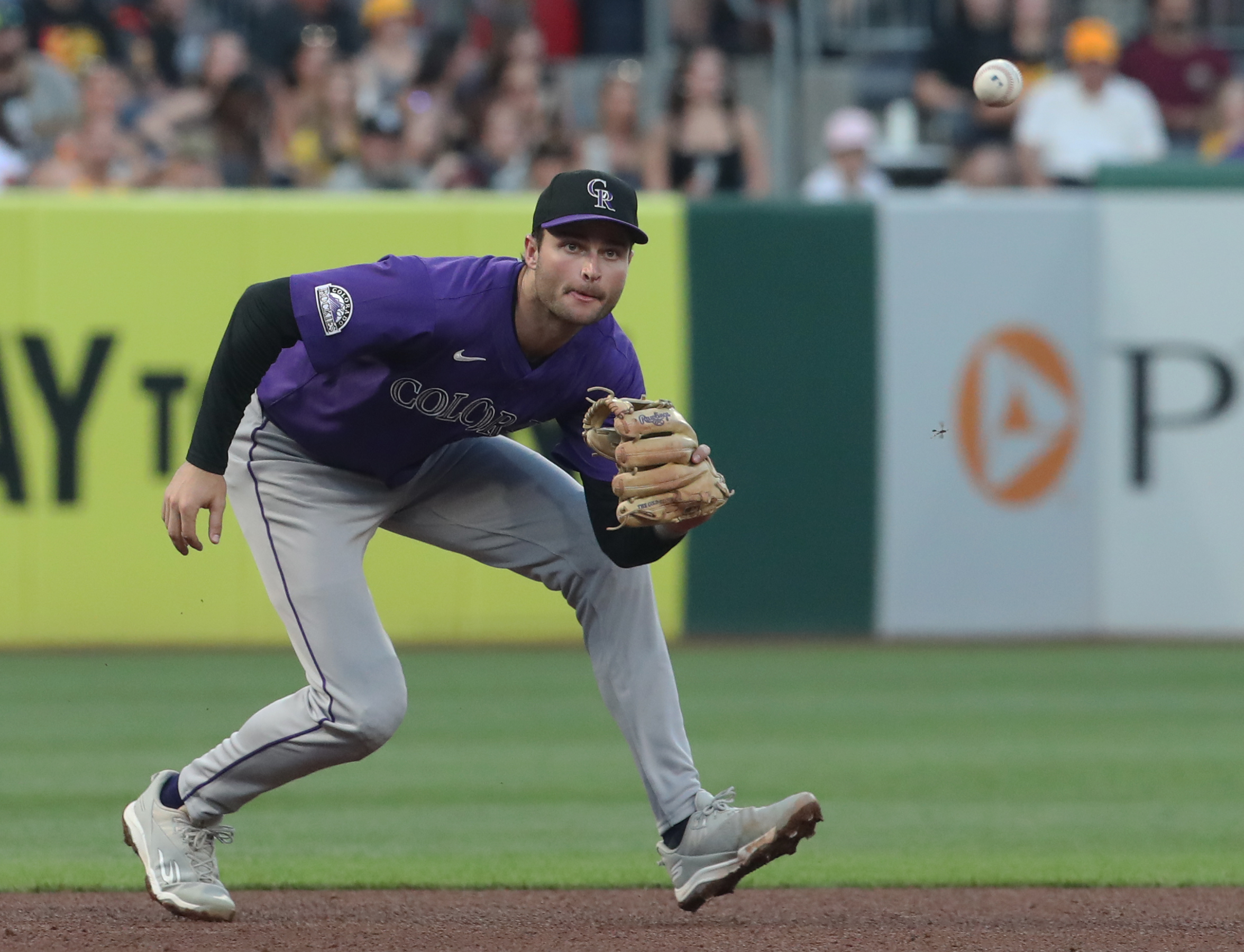 Aug 23, 2025; Pittsburgh, Pennsylvania, USA; Colorado Rockies third baseman Kyle Karros (12) fields a ground ball for an out against Pittsburgh Pirates designated hitter Andrew McCutchen (not pictured) during the fourth inning at PNC Park. Mandatory Credit: Charles LeClaire-Imagn Images