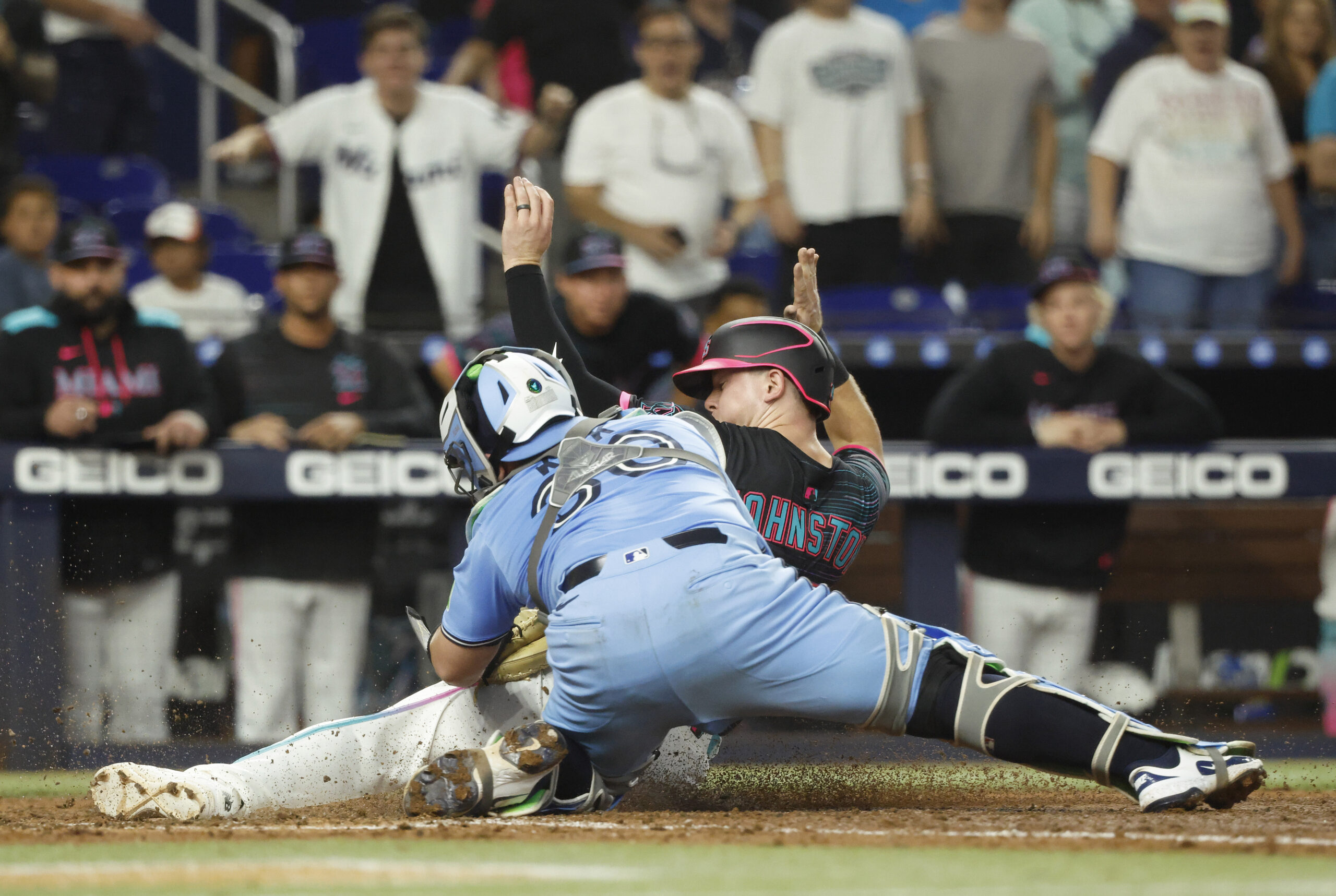 Aug 23, 2025; Miami, Florida, USA; Toronto Blue Jays catcher Alejandro Kirk (30) tags out Miami Marlins outfielder Troy Johnston (75) at the plate during the seventh inning at loanDepot Park. Mandatory Credit: Rhona Wise-Imagn Images