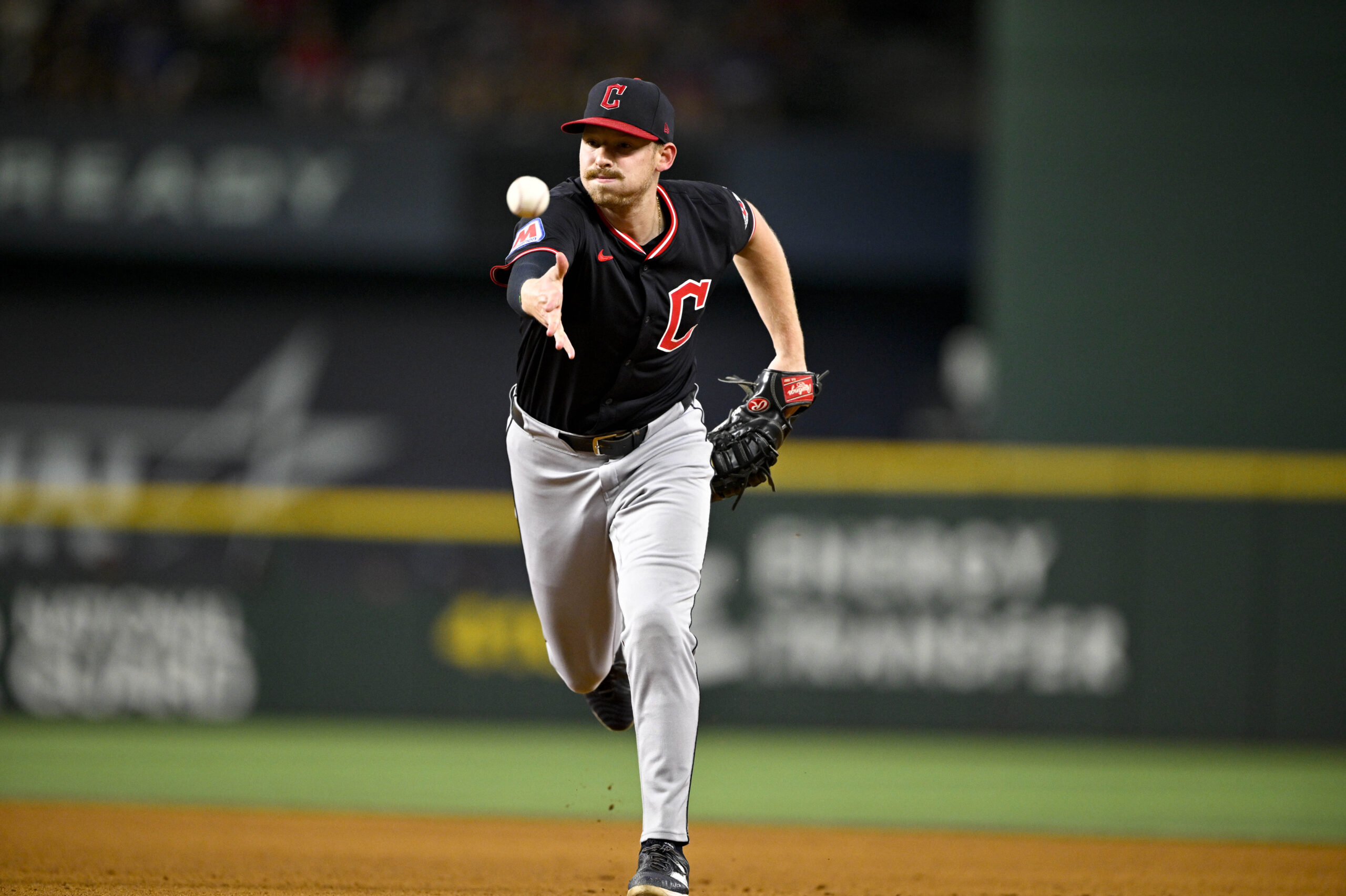 Aug 23, 2025; Arlington, Texas, USA; Cleveland Guardians first baseman Kyle Manzardo (9) tosses the ball to first base during the game against the Texas Rangers at Globe Life Field. Mandatory Credit: Jerome Miron-Imagn Images