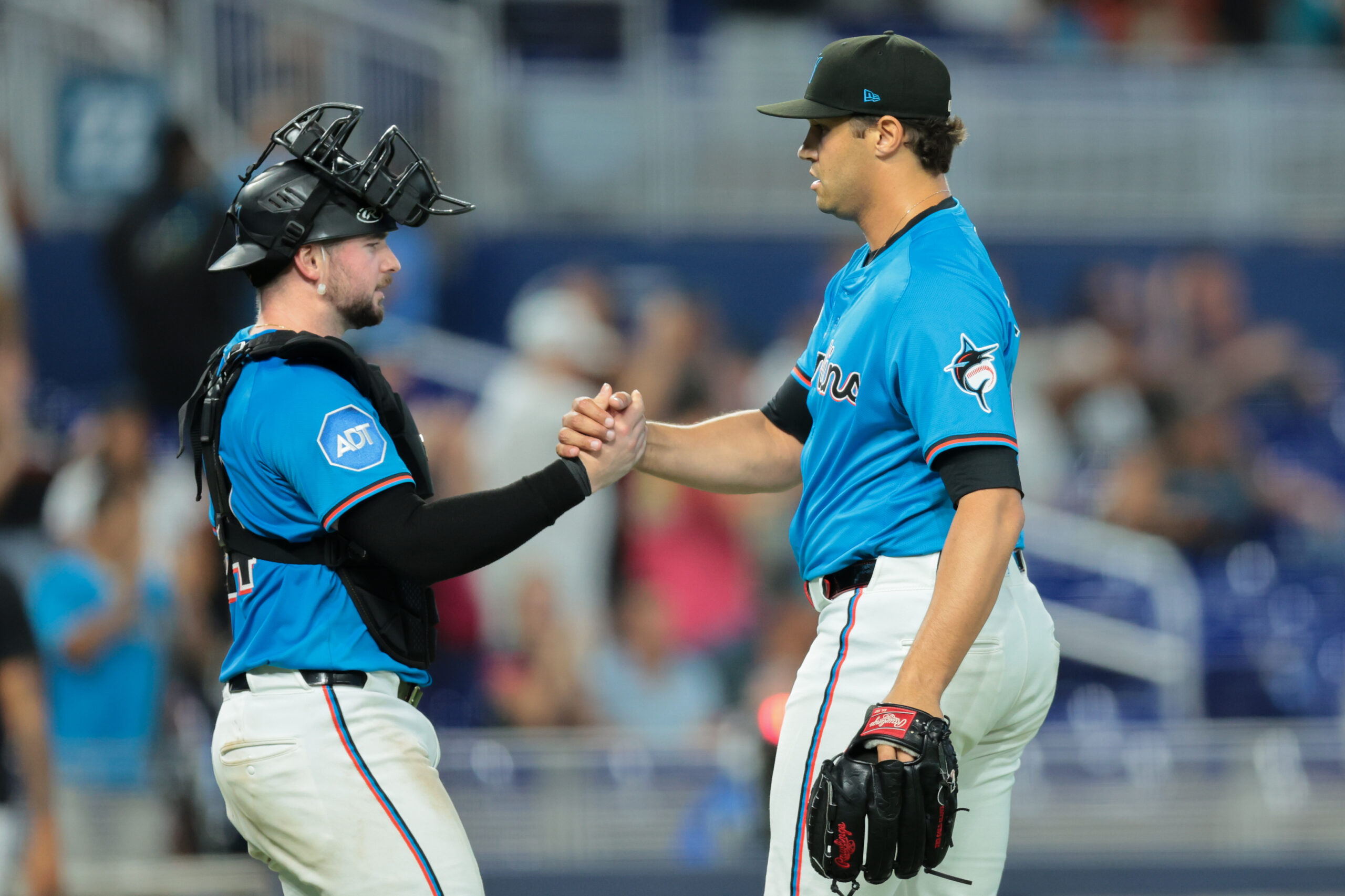 Aug 24, 2025; Miami, Florida, USA; Miami Marlins catcher Liam Hicks (34) and relief pitcher Tyler Phillips (30) celebrate after the game against the Toronto Blue Jays at loanDepot Park. Mandatory Credit: Sam Navarro-Imagn Images
