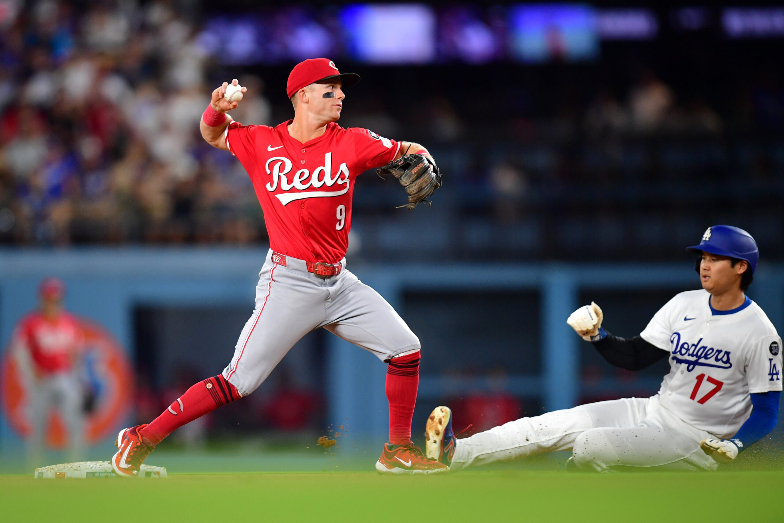 Aug 25, 2025; Los Angeles, California, USA; Los Angeles Dodgers two-way player Shohei Ohtani (17) is out at second as Cincinnati Reds second base Matt McLain (9) throws to first in a double play in the third inning at Dodger Stadium. Mandatory Credit: Gary A. Vasquez-Imagn Images
