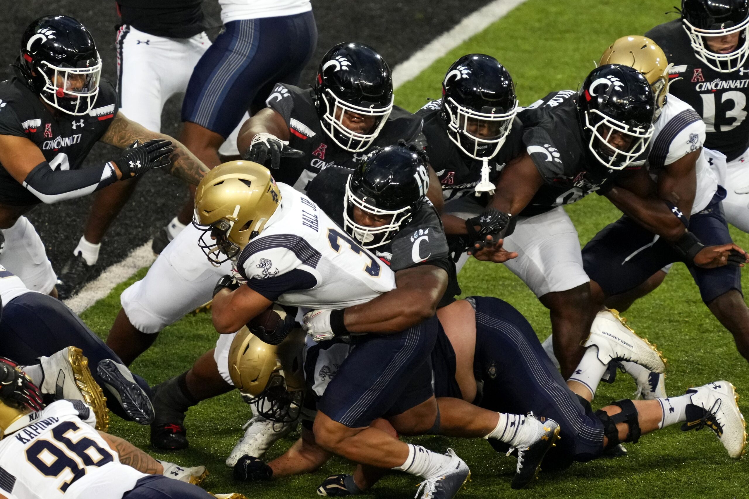 Navy Midshipmen fullback Anton Hall Jr. (34) carries the ball as Cincinnati Bearcats defensive lineman Jowon Briggs (18) makes the tackle near the goal line in the third quarter during a college football game, Saturday, Nov. 5, 2022, at Nippert Stadium in Cincinnati. The Cincinnati Bearcats won, 20-10.

Ncaaf Navy Midshipmen At Cincinnati Bearcats Nov 6 0672