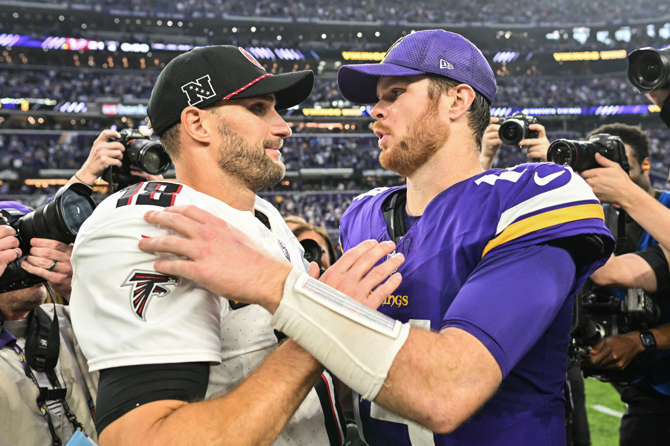 Dec 8, 2024; Minneapolis, Minnesota, USA; Atlanta Falcons quarterback Kirk Cousins (18) and Minnesota Vikings quarterback Sam Darnold (14) talk after the game at U.S. Bank Stadium. Mandatory Credit: Jeffrey Becker-Imagn Images