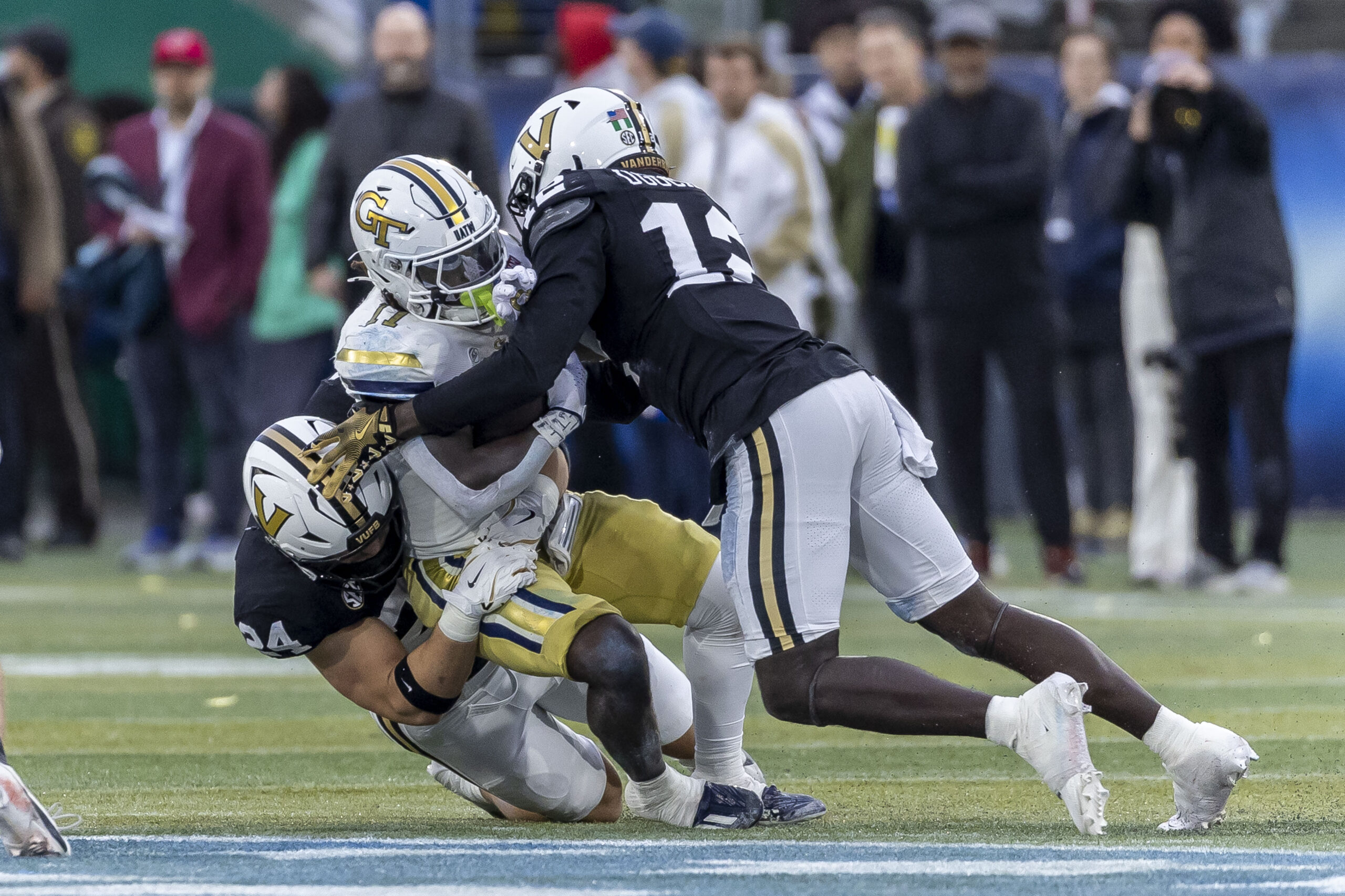 Dec 27, 2024; Birmingham, AL, USA;  Vanderbilt Commodores linebackers Nick Rinaldi (24) and Jeffrey Ugochukwu (12) stop Georgia Tech Yellow Jackets running back Jamal Haynes (11) during the first half of the 2024 Birmingham Bowl at Protective Stadium. Mandatory Credit: Vasha Hunt-Imagn Images