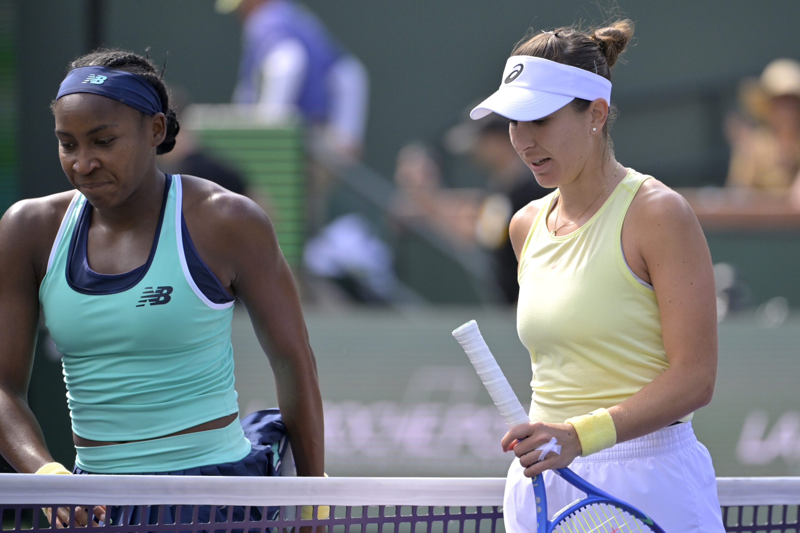 Mar 12, 2025; Indian Wells, CA, USA;  Coco Gauff (USA) and Belinda Bencic (SUI) leave the court following the fourth round of the BNP Paribas Open at the Indian Well Tennis Garden. Mandatory Credit: Jayne Kamin-Oncea-Imagn Images