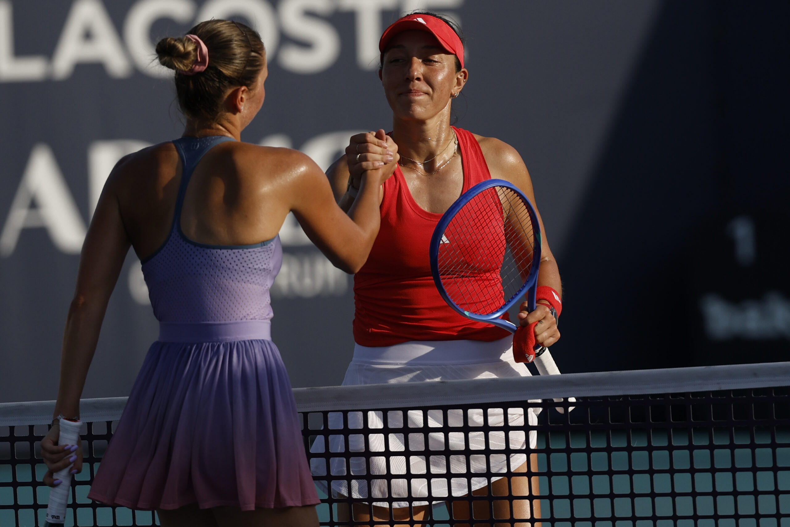 Mar 24, 2025; Miami, FL, USA; Jessica Pegula (USA)(R) shakes hands with Marta Kostyuk (UKR)(L) at the net after their match on day seven of the Miami Open at Hard Rock Stadium. Mandatory Credit: Geoff Burke-Imagn Images