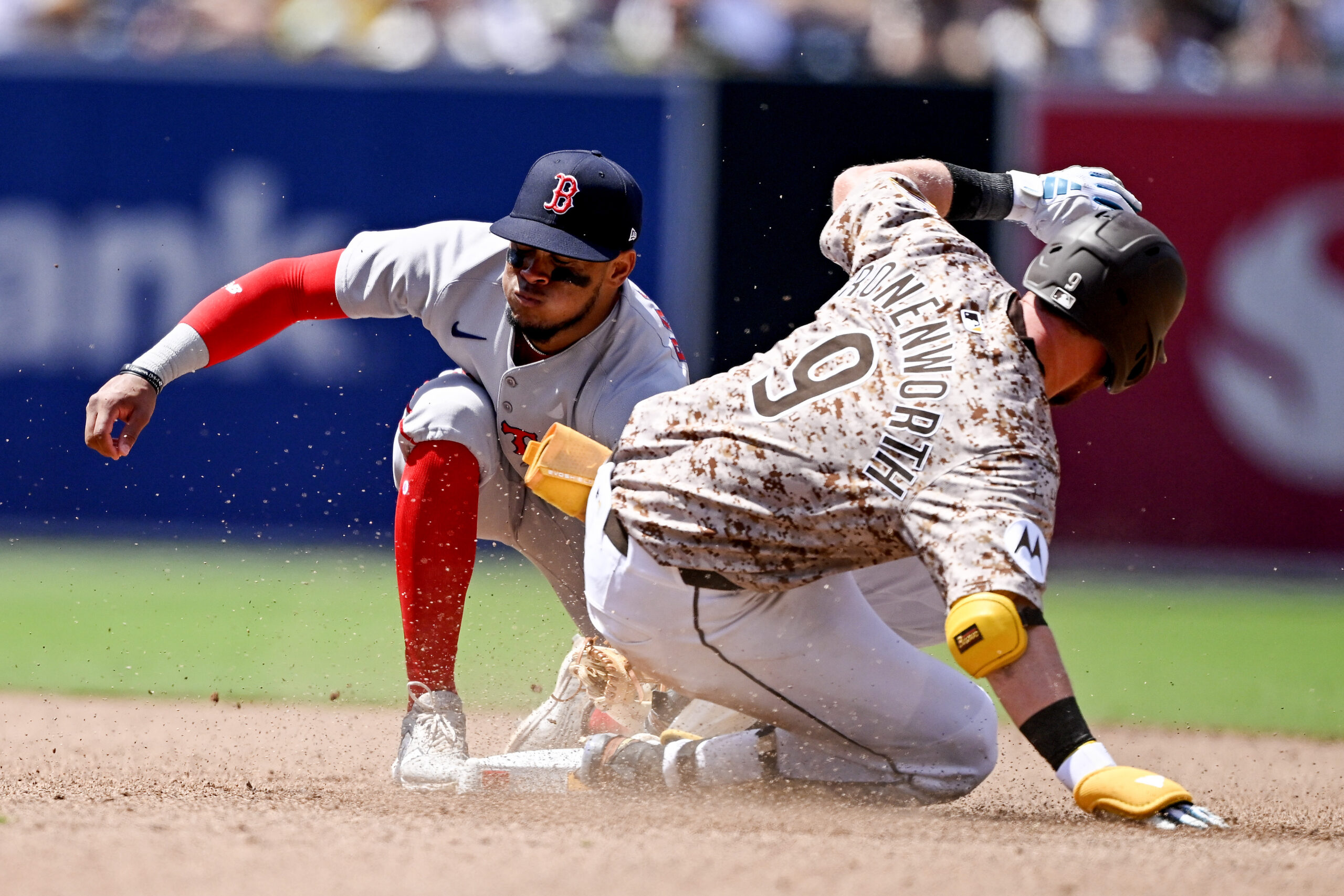 Aug 10, 2025; San Diego, California, USA; San Diego Padres second baseman Jake Cronenworth (9) slides into second base with a double ahead of the tag of Boston Red Sox second baseman Ceddanne Rafaela (3) during the fifth inning at Petco Park. Mandatory Credit: Denis Poroy-Imagn Images