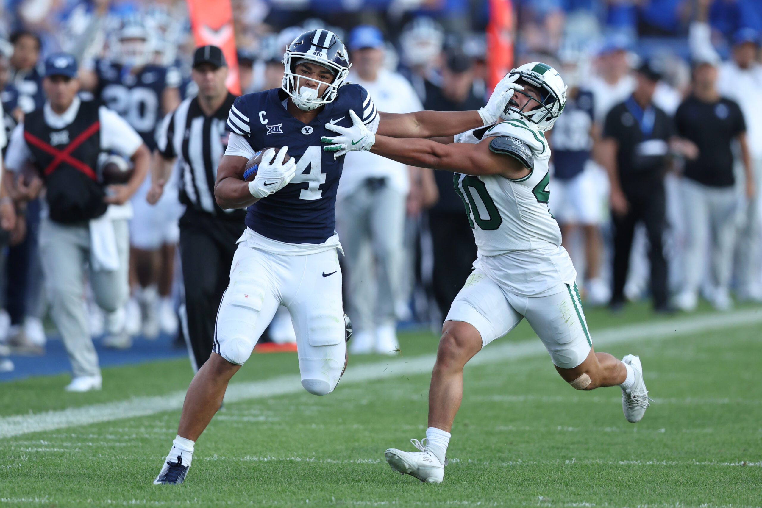 Aug 30, 2025; Provo, Utah, USA; Brigham Young Cougars running back LJ Martin (4) runs the ball against Portland State Vikings linebacker Lonnie Burt (40) during the second quarter at LaVell Edwards Stadium. Mandatory Credit: Rob Gray-Imagn Images
