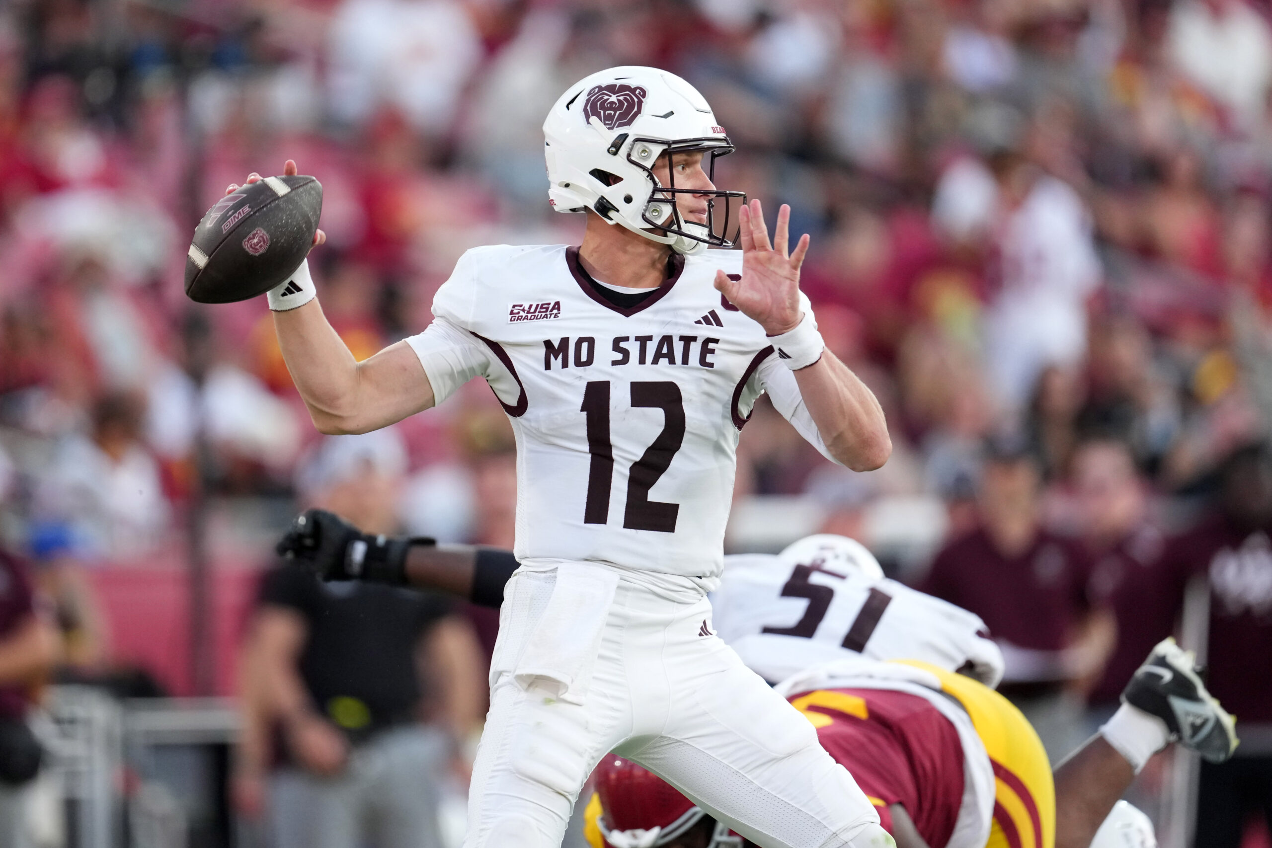 Aug 30, 2025; Los Angeles, California, USA; Missouri State Bears quarterback Jacob Clark (12) throws the ball against the Southern California Trojans in the second half at United Airlines Field at Los Angeles Memorial Coliseum. Mandatory Credit: Kirby Lee-Imagn Images