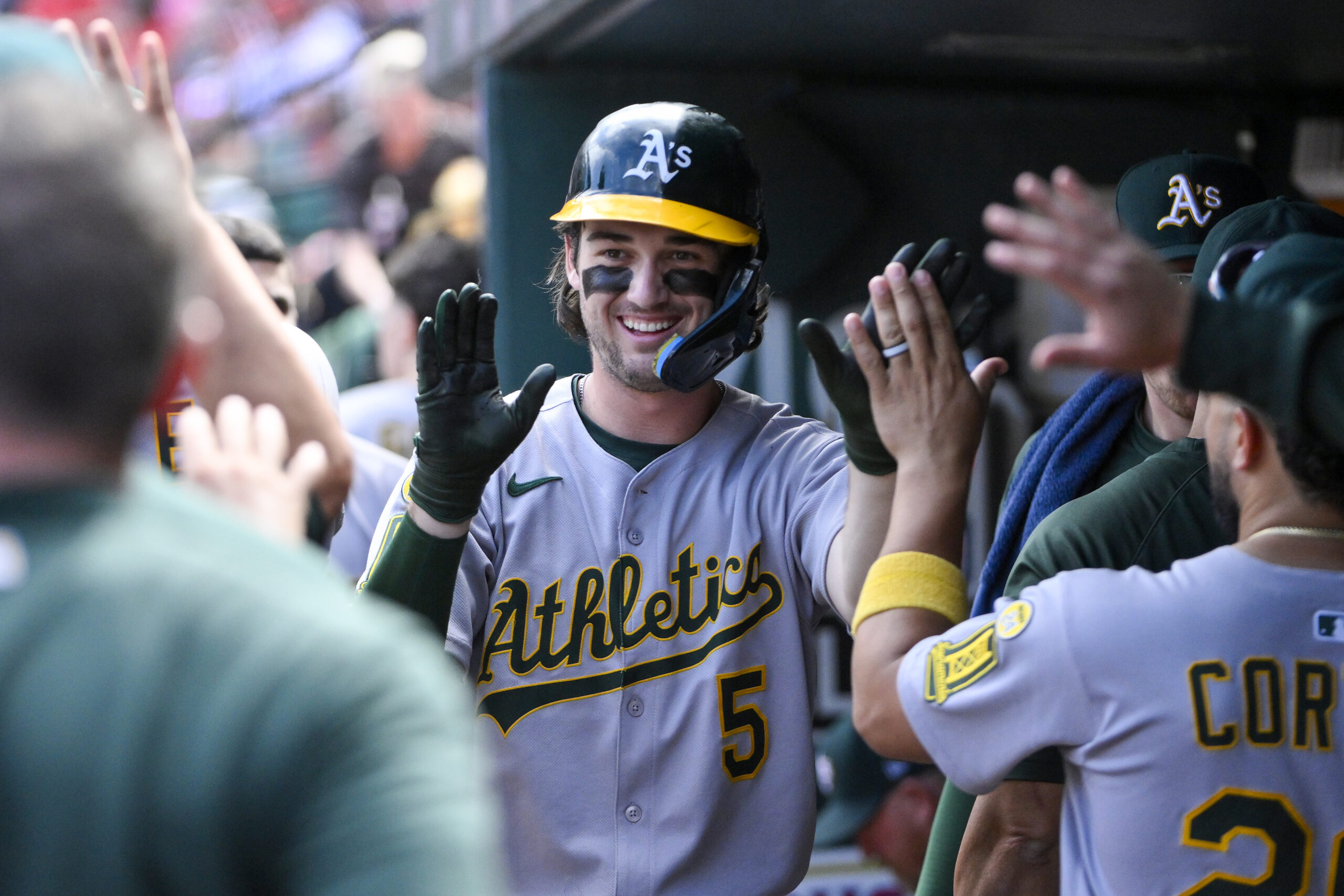 Sep 1, 2025; St. Louis, Missouri, USA; Athletics shortstop Jacob Wilson (5) is congratulated by teammates after scoring against the St. Louis Cardinals during the seventh inning at Busch Stadium. Mandatory Credit: Jeff Curry-Imagn Images